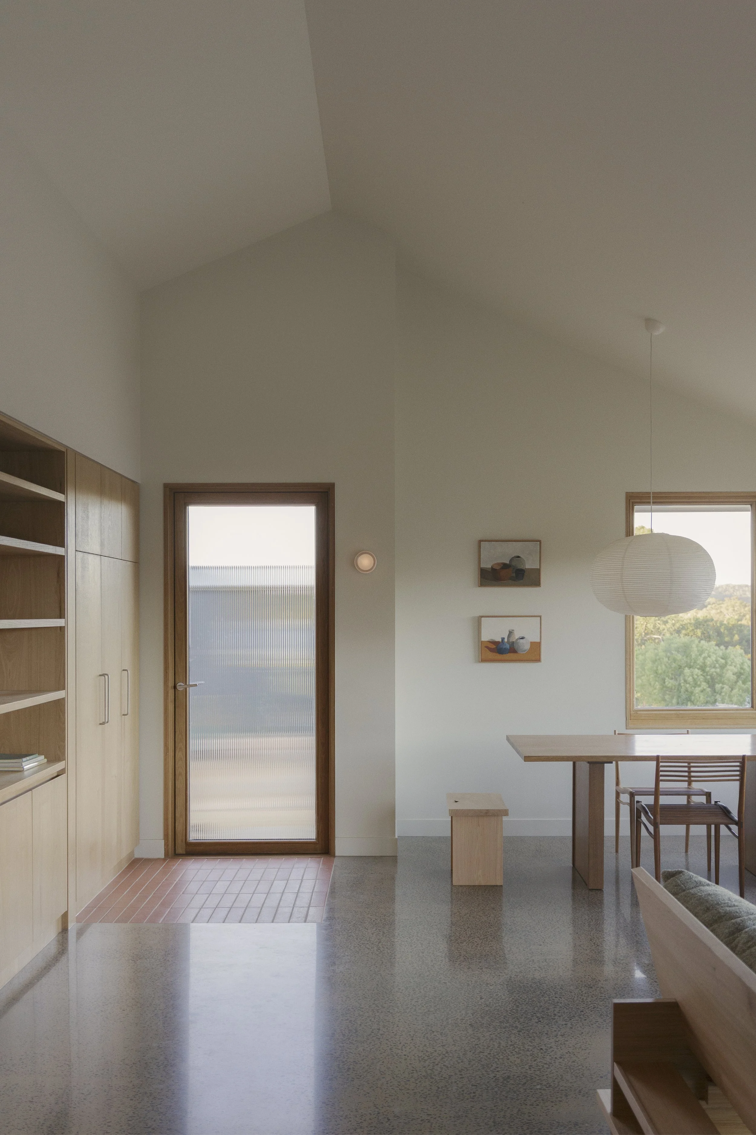 Living, dining and entryway in Australian architecturally designed bush modern home in Chewton, Victoria.