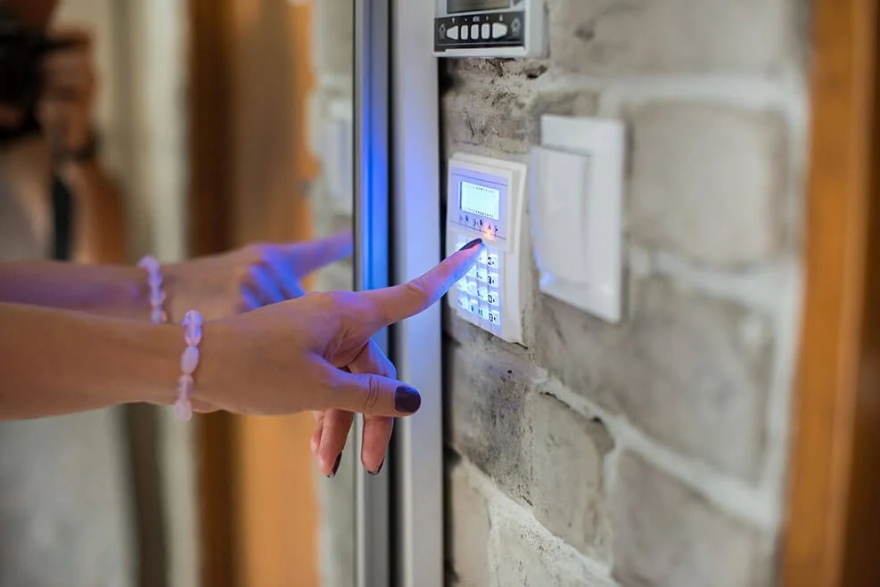 woman-entering-password-on-home-alarm-keypad.jpg