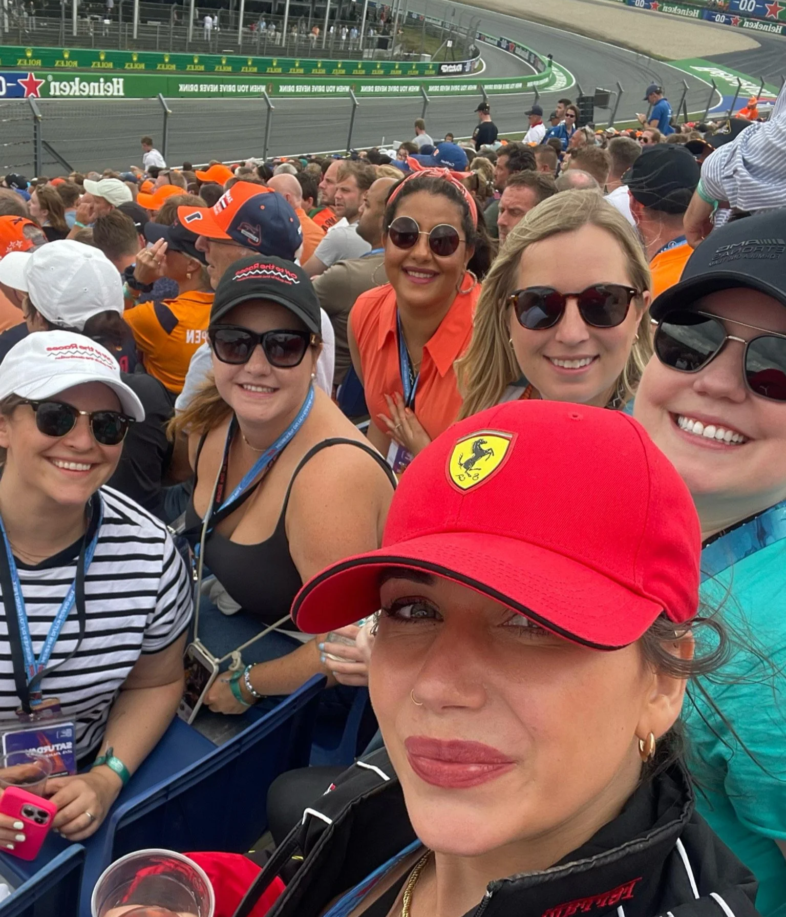 Group of OTTR guests cheering together in the grandstand during a Formula 1 race