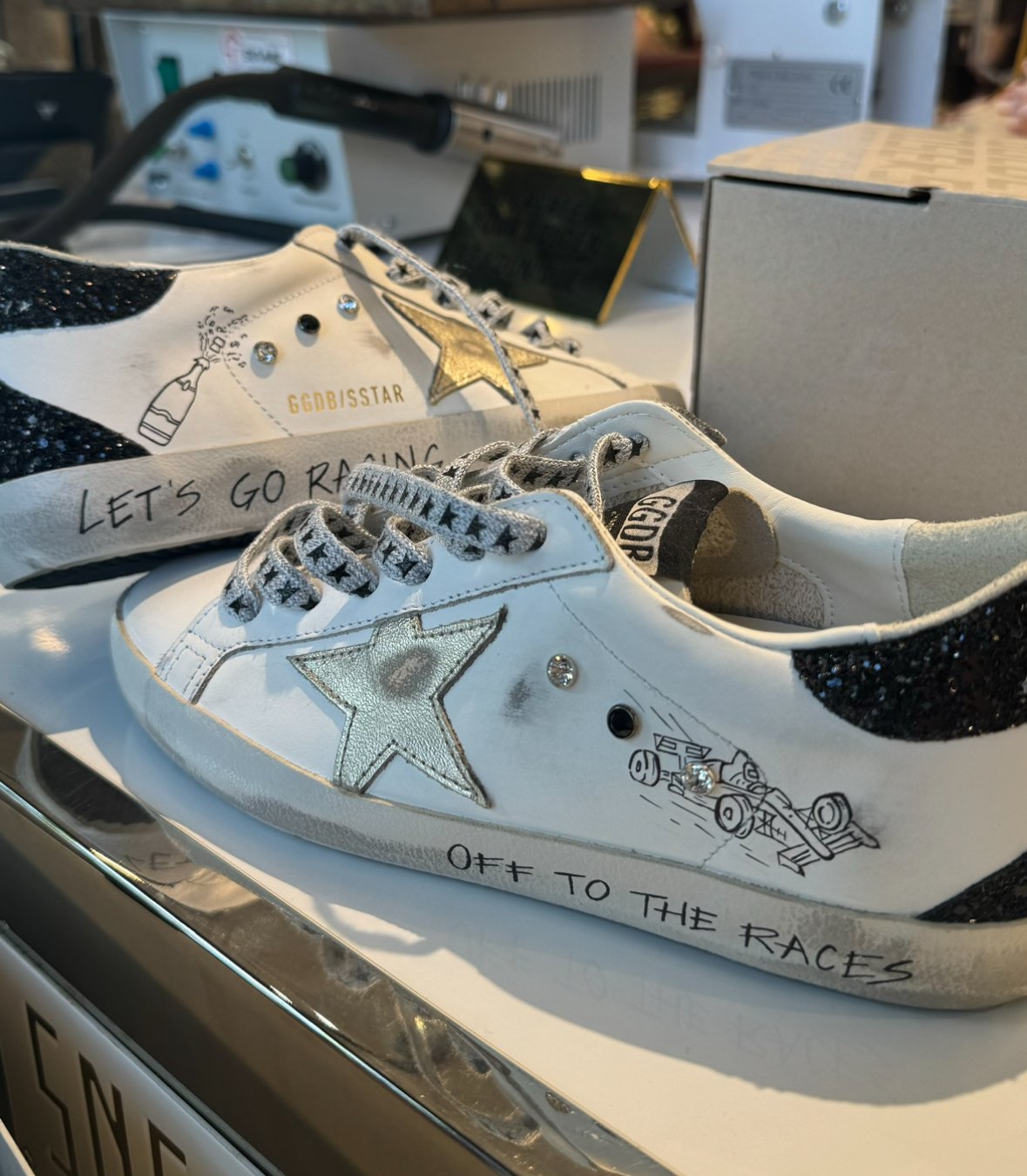 Formula 1-inspired Golden Goose sneakers styled as a race day outfit accessory for a Grand Prix weekend
