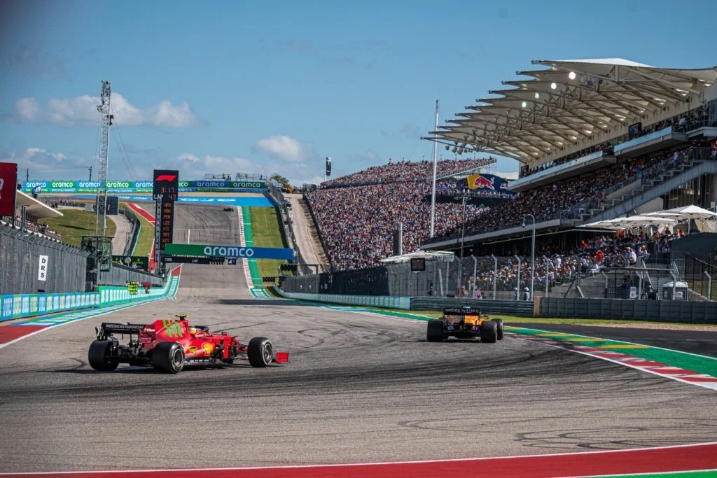 Formula 1 cars racing uphill into Turn 1 at the Circuit of the Americas in Austin Texas