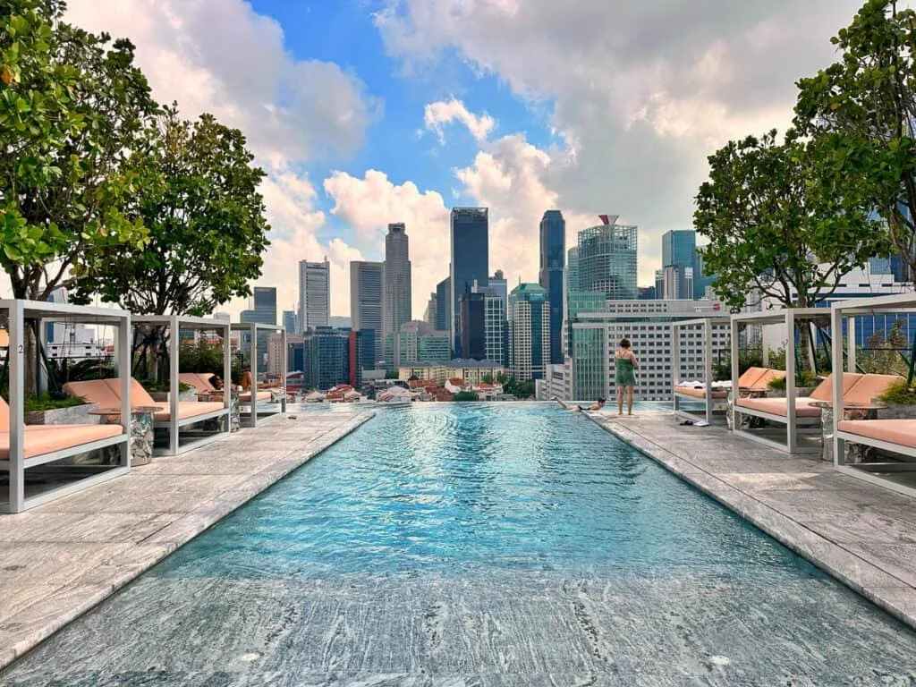 The Mondrian Singapore Duxton hotel featuring a rooftop pool with views of the Singapore city skyline