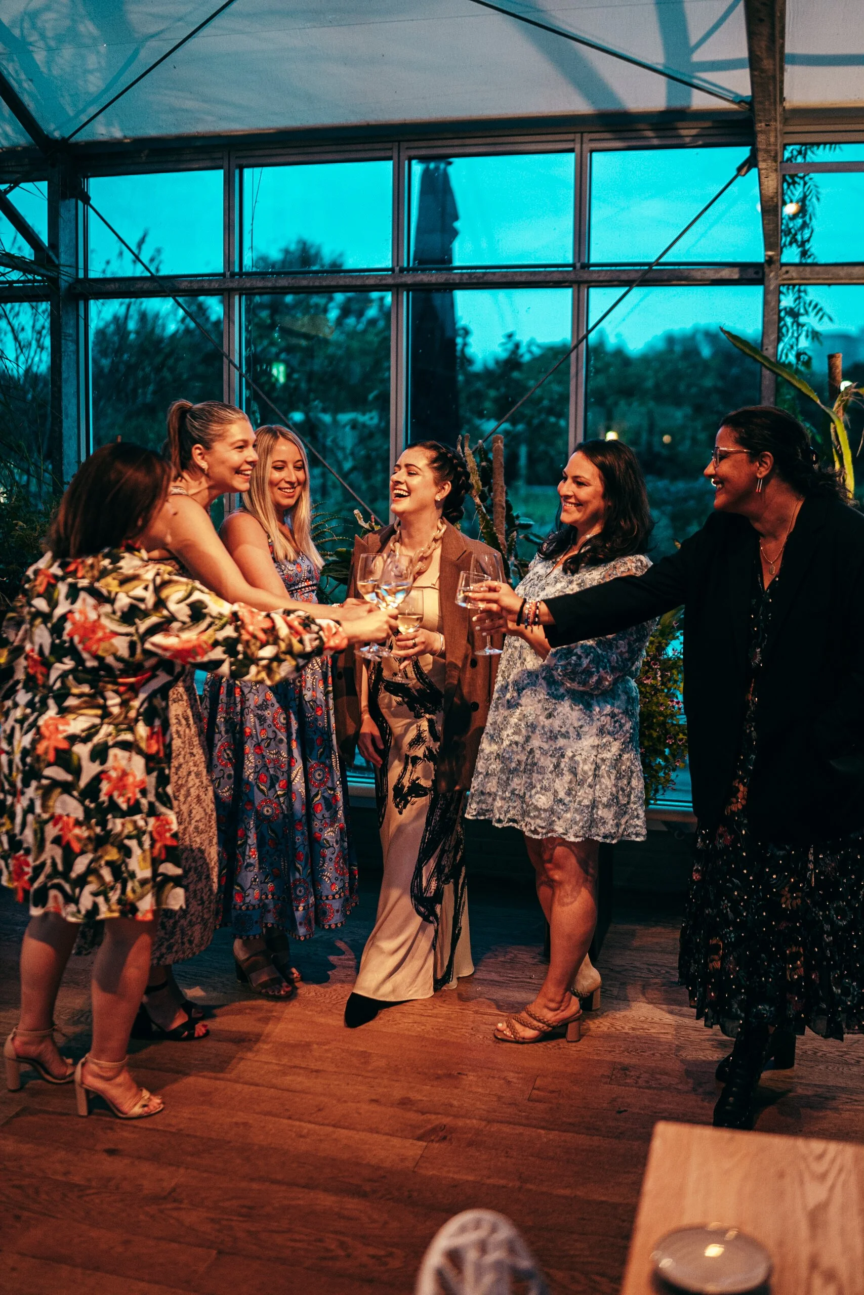 OTTR guests laughing together at a welcome cocktail party during a race weekend