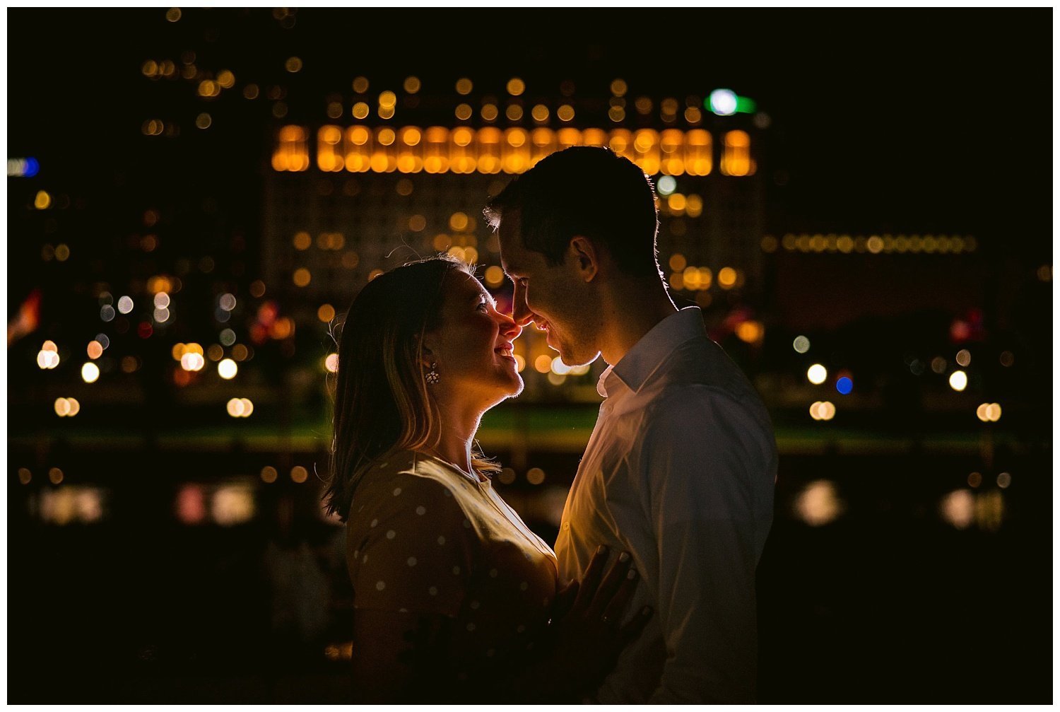 Cinematic Engagement Photo at Night along the Scioto Mile over looking Columbus Ohio Skyline