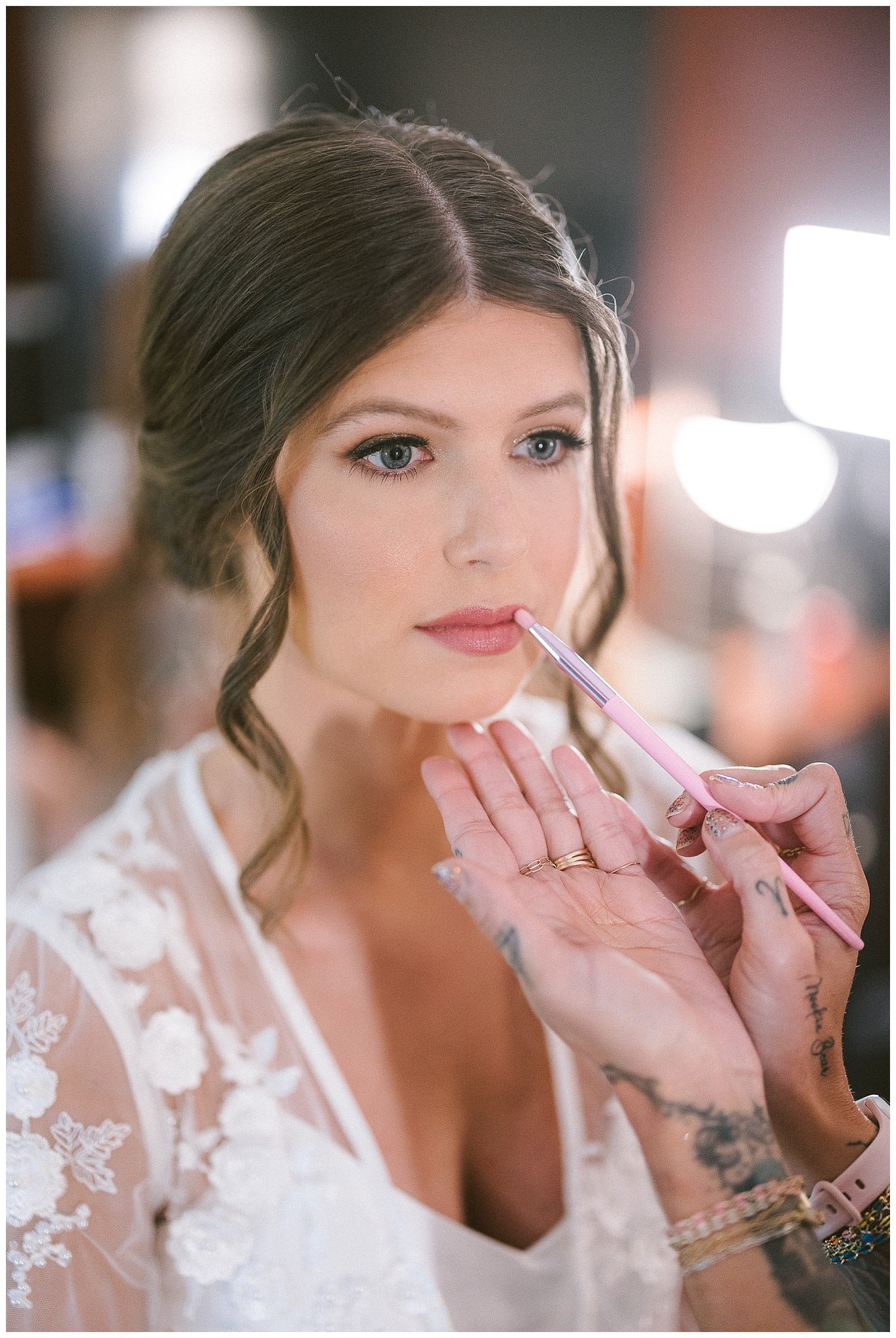 a close up photo of a bride getting her makeup done
