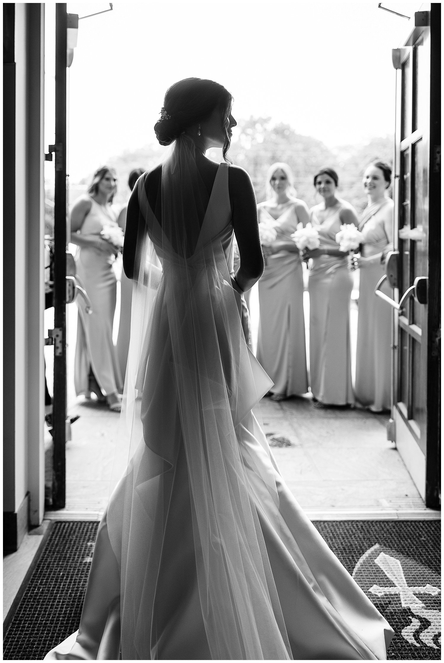 photo of a bride seeing her bridesmaids for the first time