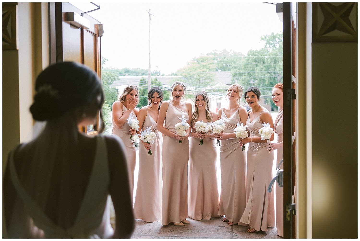 photo of a bride doing a first look with her bridesmaids