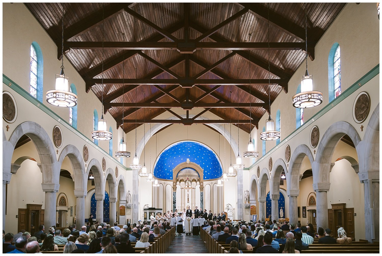 A wide angle photo of a wedding couple during their wedding at St. Michael's Church in Worthington. 