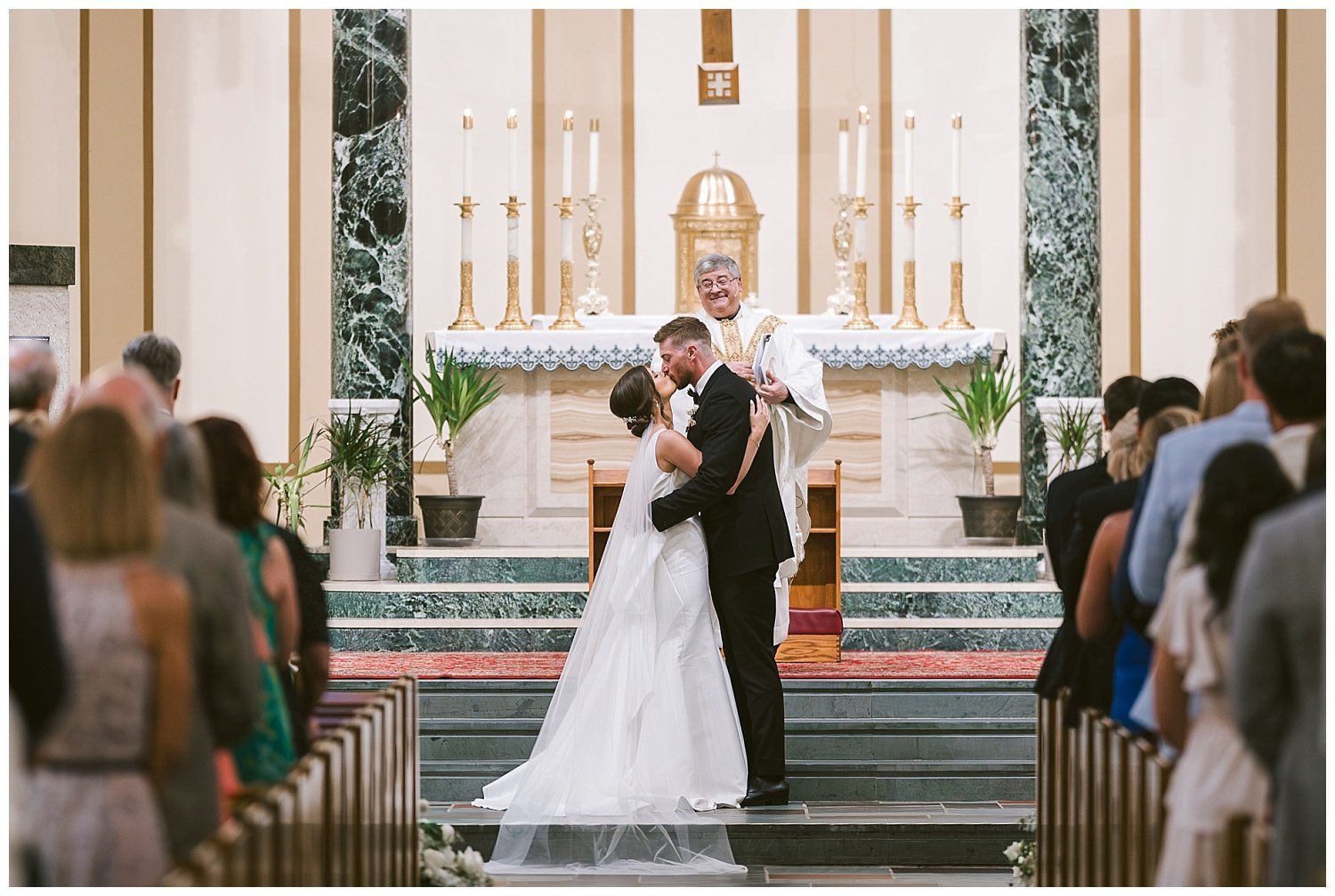 A wedding couple's first kiss during their wedding at St. Michael's Church in Worthington. 