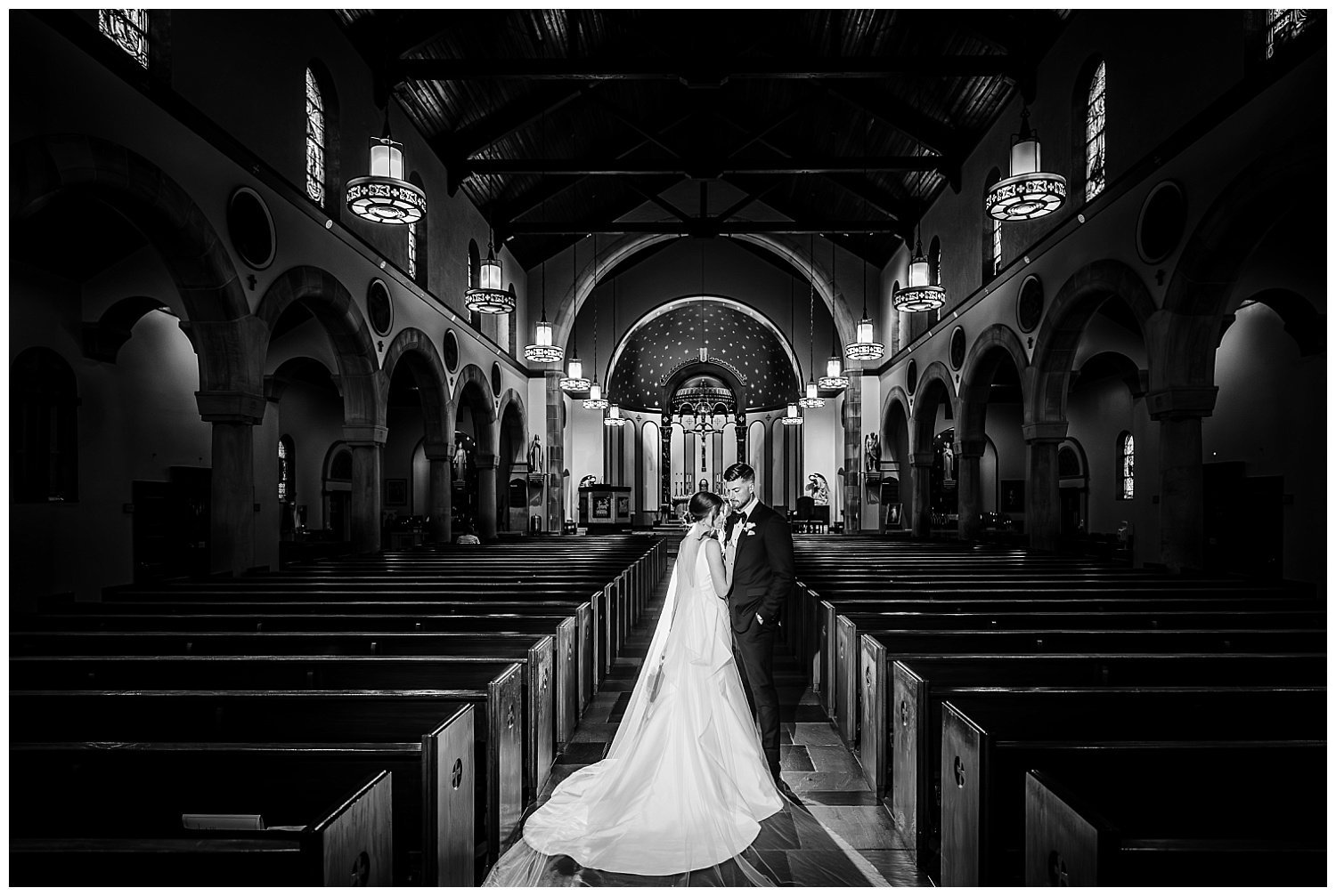 A cinematic photo of a bride and groom posing for wedding photos in St. Michael's Church in Worthington, Ohio. 