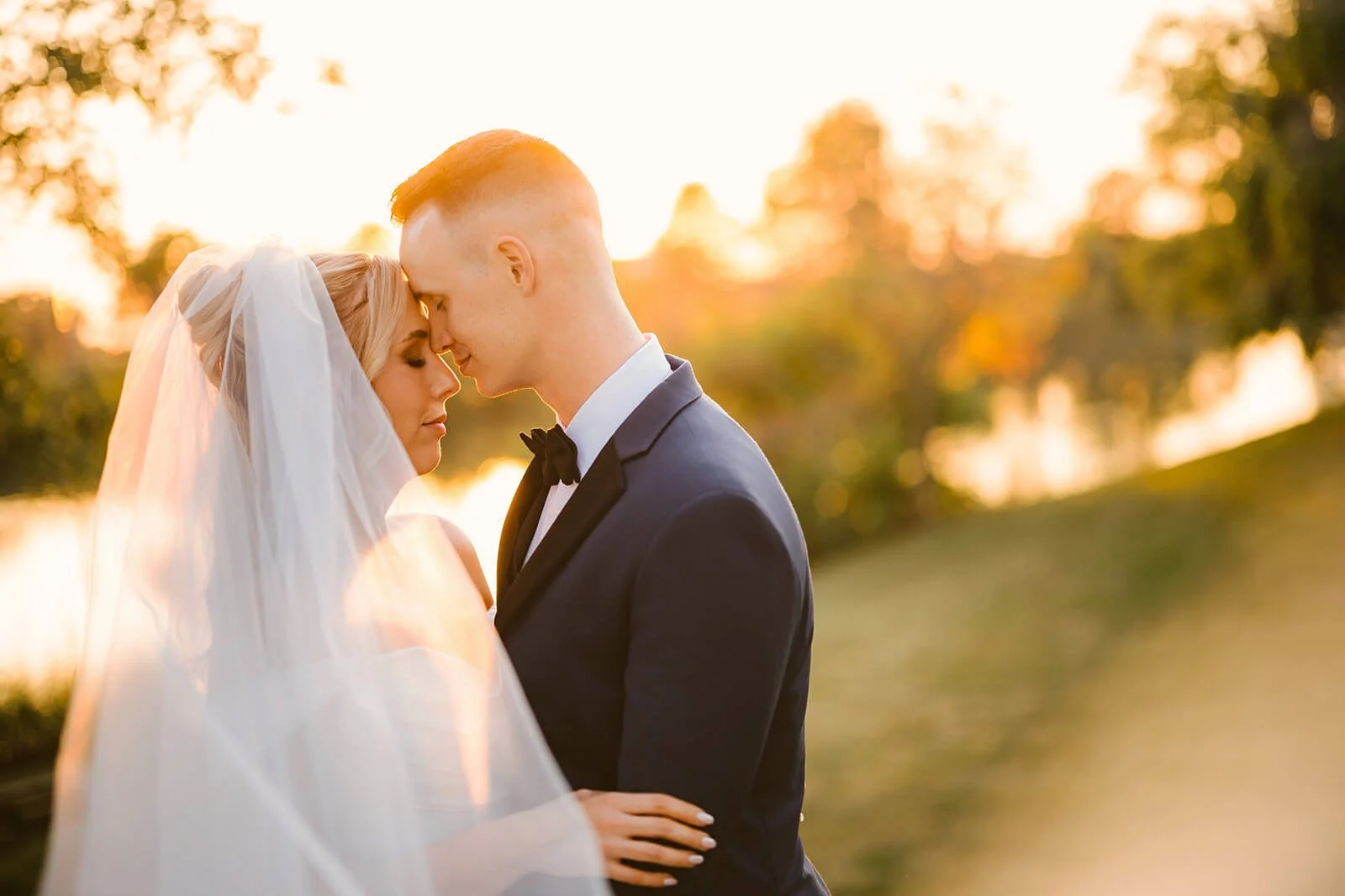 Bride and groom sharing an intimate moment during golden hour portraits by Columbus wedding photographer Robb McCormick