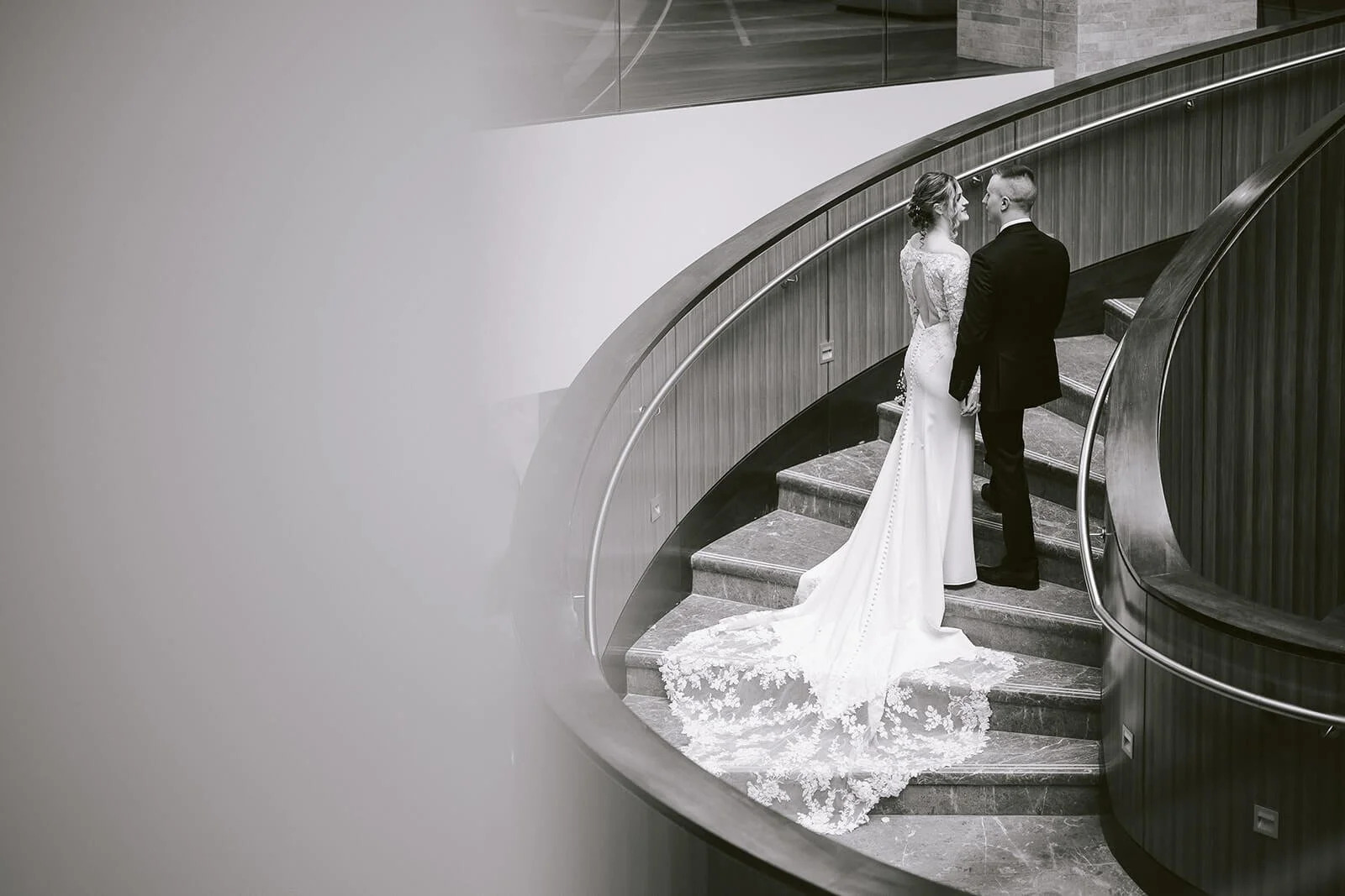 Black and white wedding portrait of bride and groom on a curved staircase by Columbus wedding photographer Robb McCormick