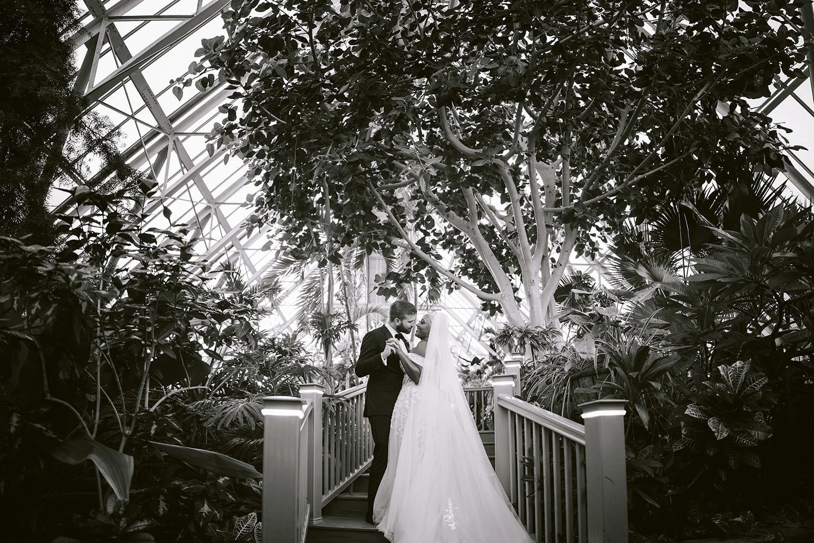 Bride and Groom sharing an intimate moment during their first look in a tropical botanical garden.