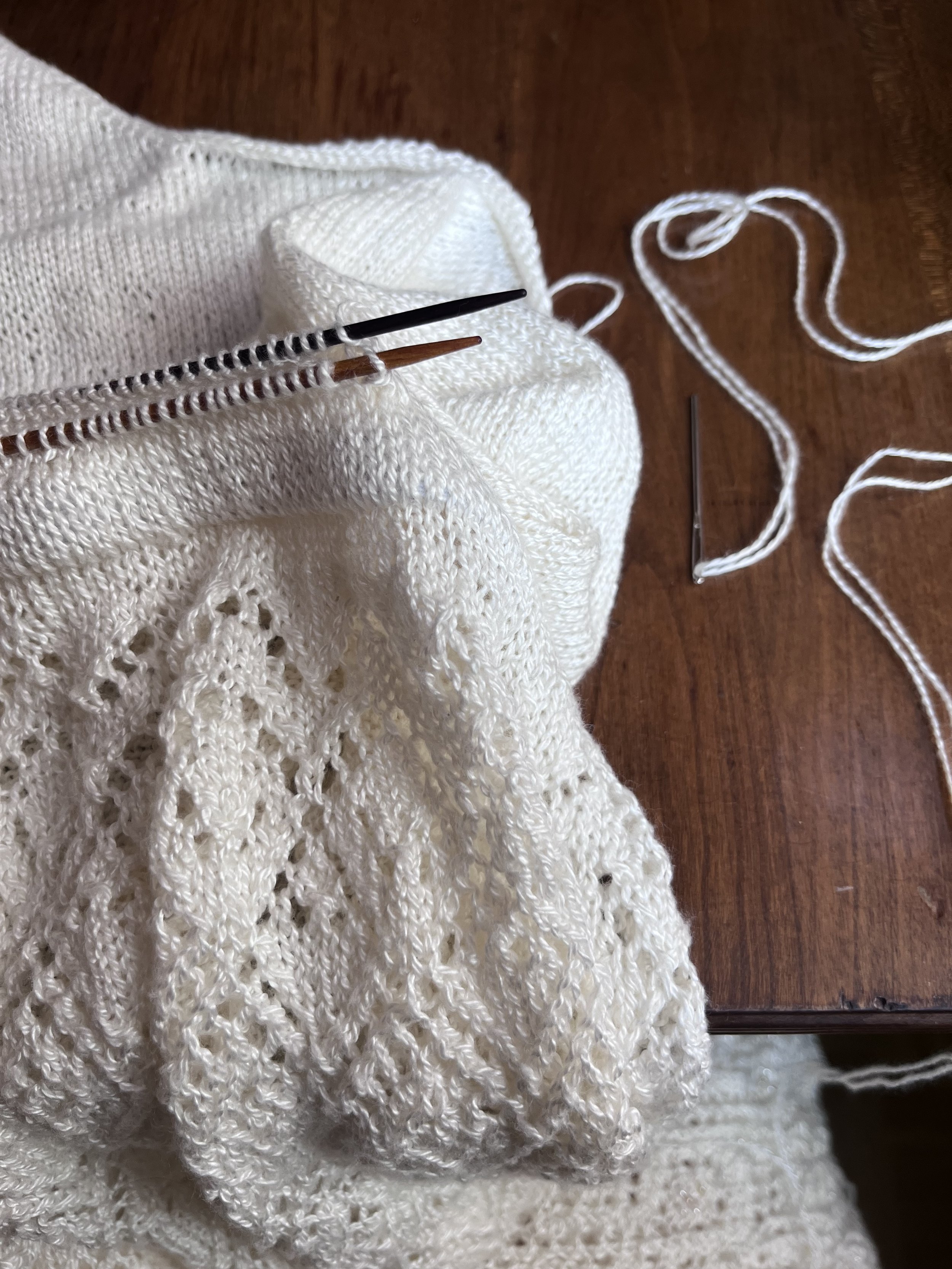 Holding the needle with the top stitches parallel with the needle with the skirt waistband stitches, I cut a length of yarn three times the circumference of the waist and began to graft the pieces together using a tapestry needle and a grafting techn