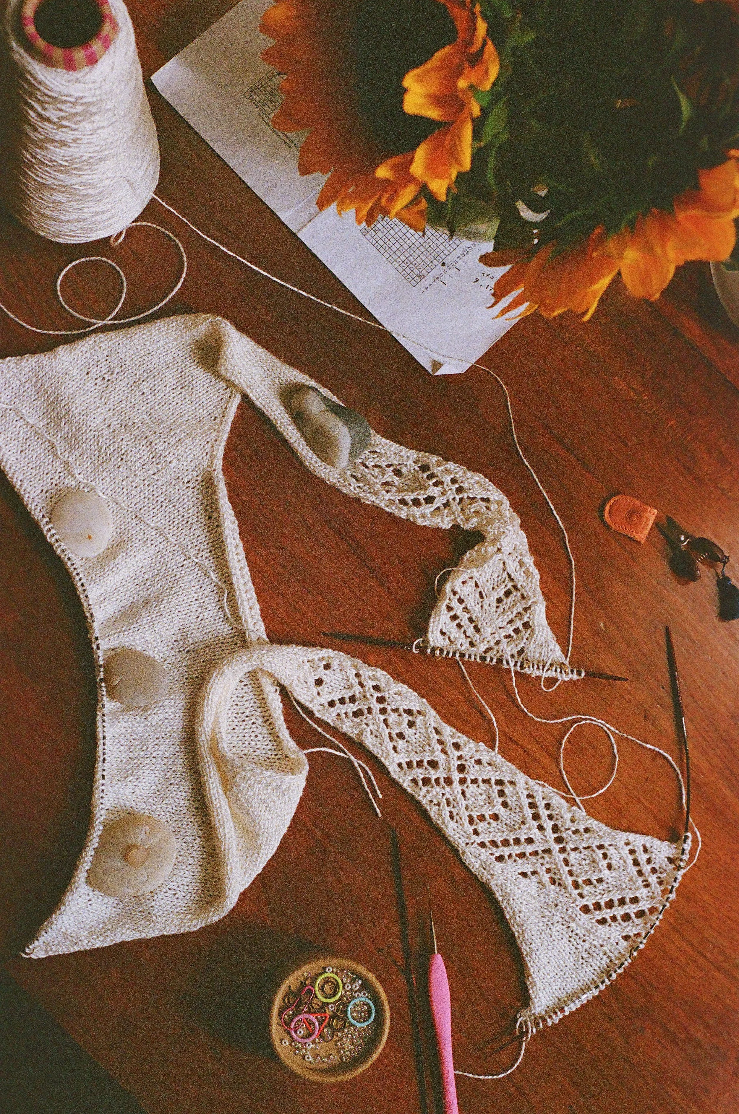 Then, using the lace motif from the skirt, I picked up the cast-on stitches for the front straps held on scrap yarn, and knitted one repeat of the lace chart for the back straps, eventually adding increases on the outer edges to start shaping the bac