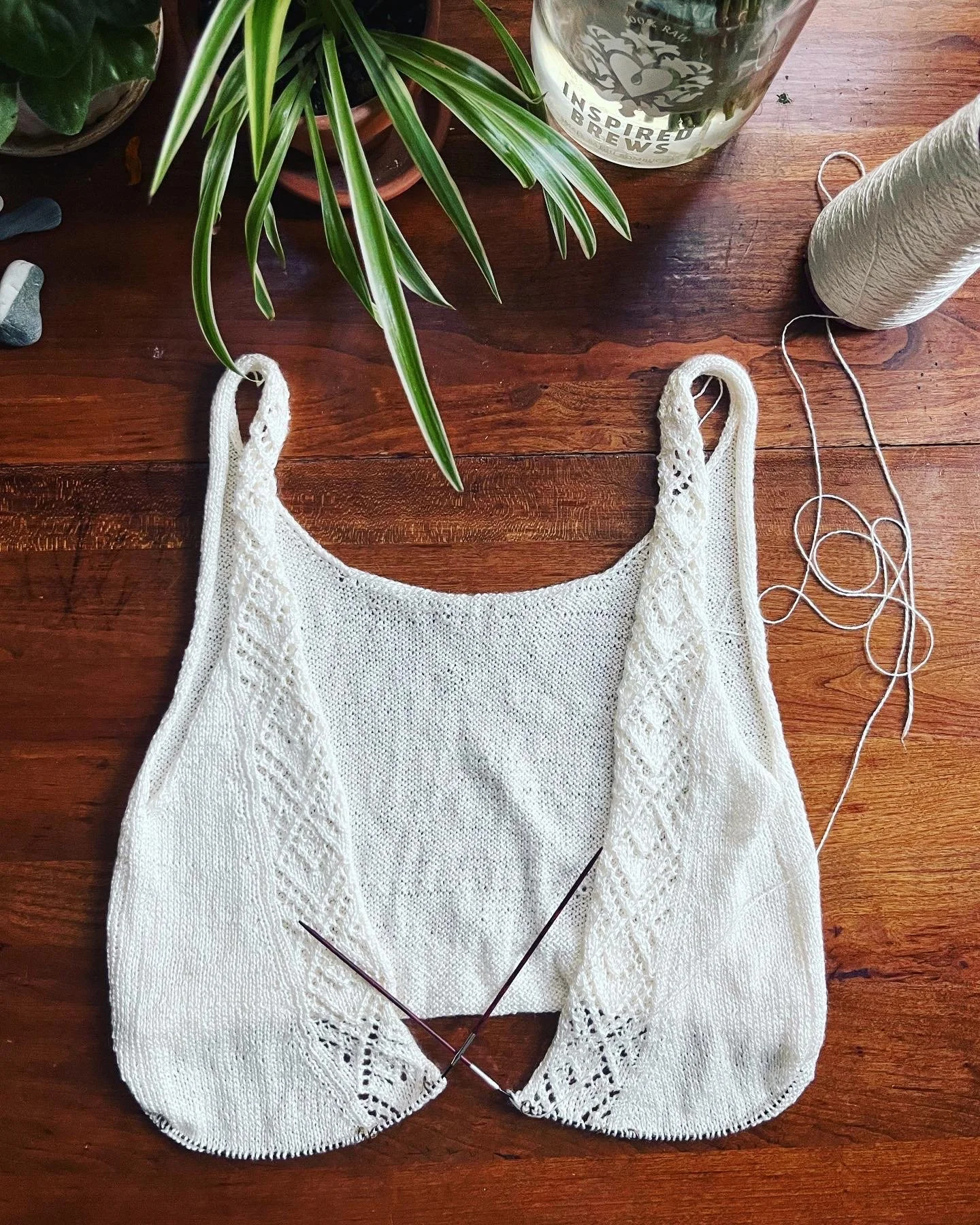 I would slip the work onto larger circumference needles to try it on as I went. Once I was just about at the right length and angle of the open back, I had to do a bit of math to make sure the total stitch count would match what was on hold for the s