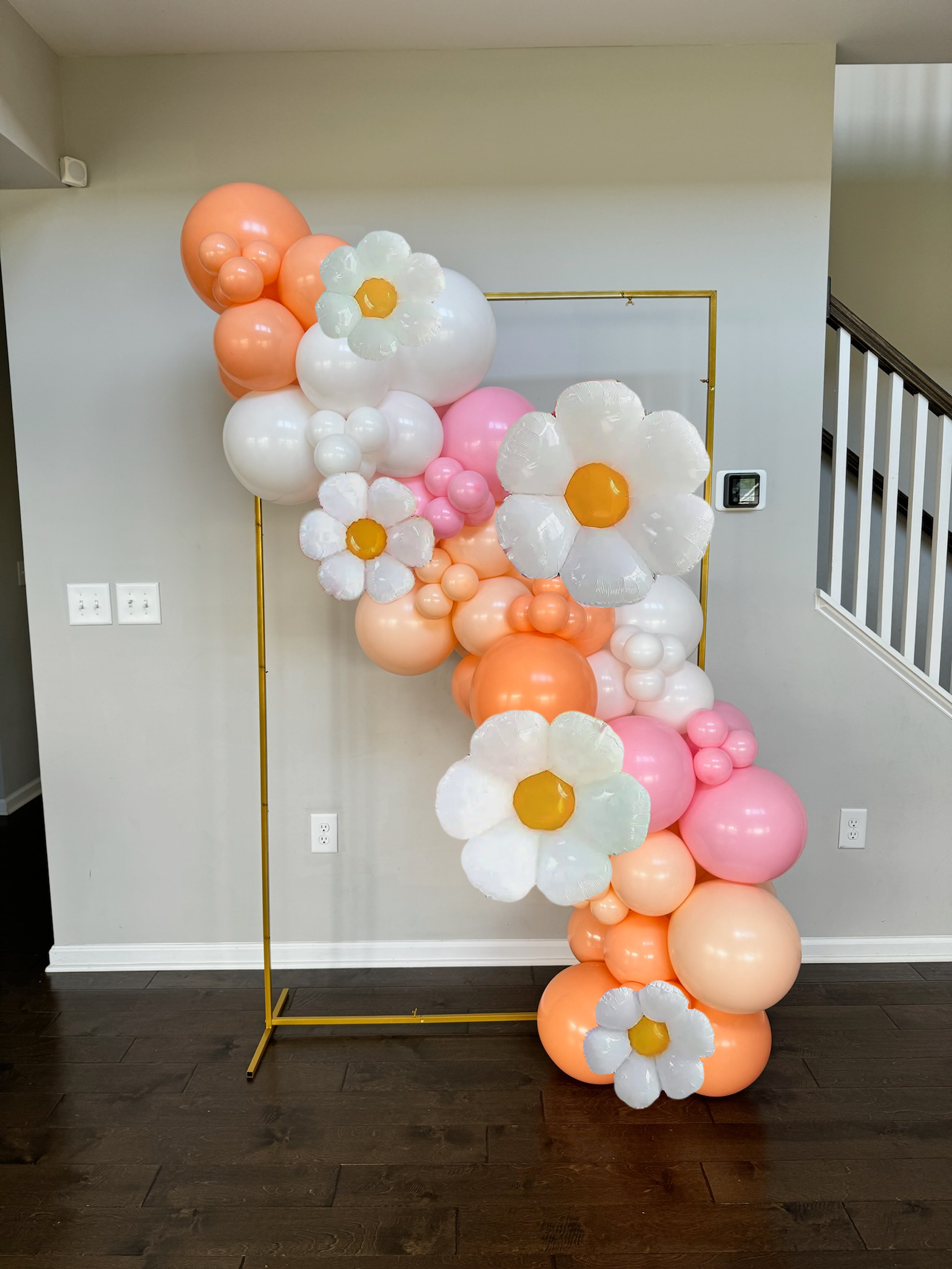 Deluxe 7-9ft garland attached to gold rectangle stand