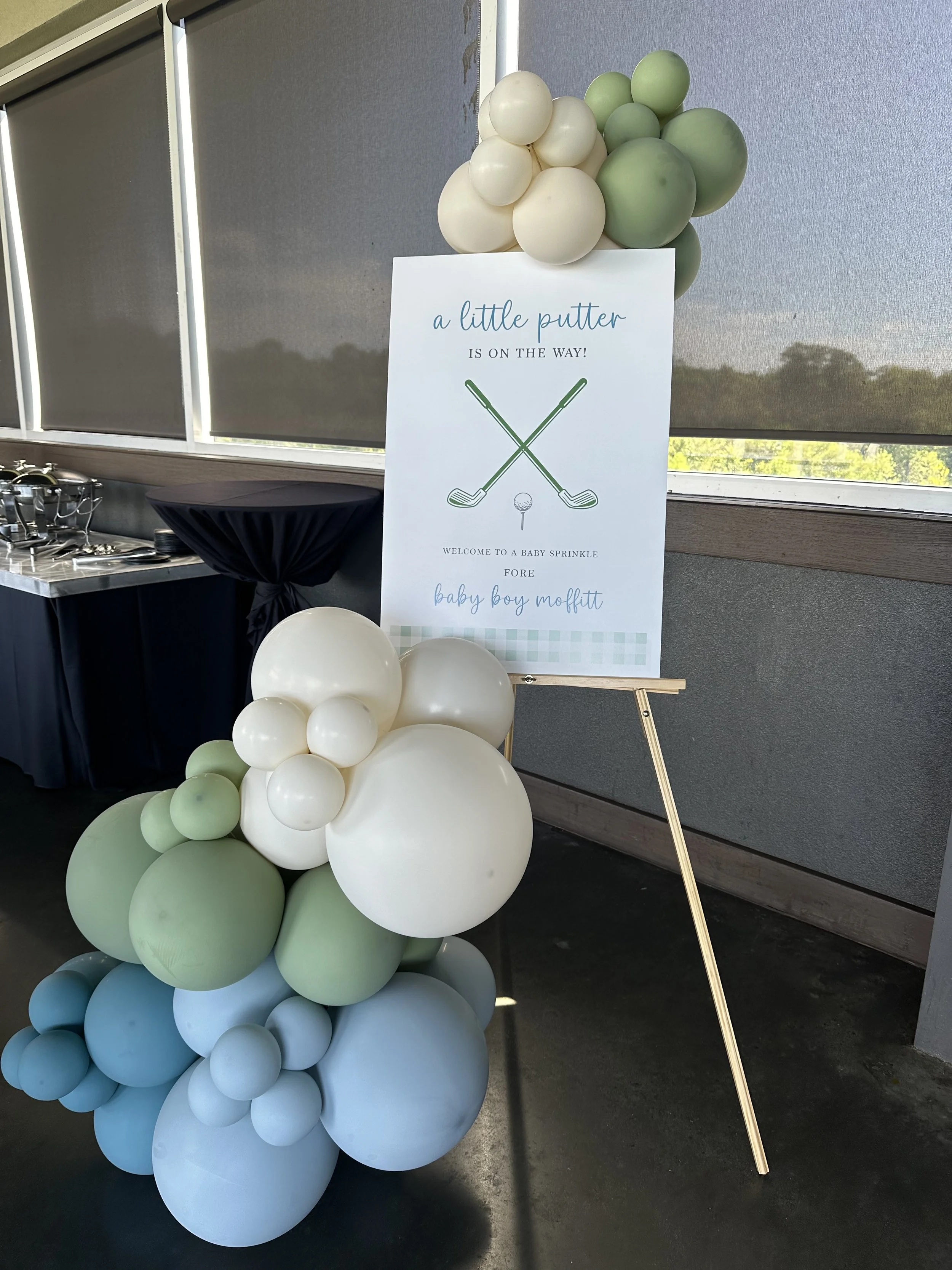 Custom welcome sign on a wooden easel with 5-6ft balloon garland