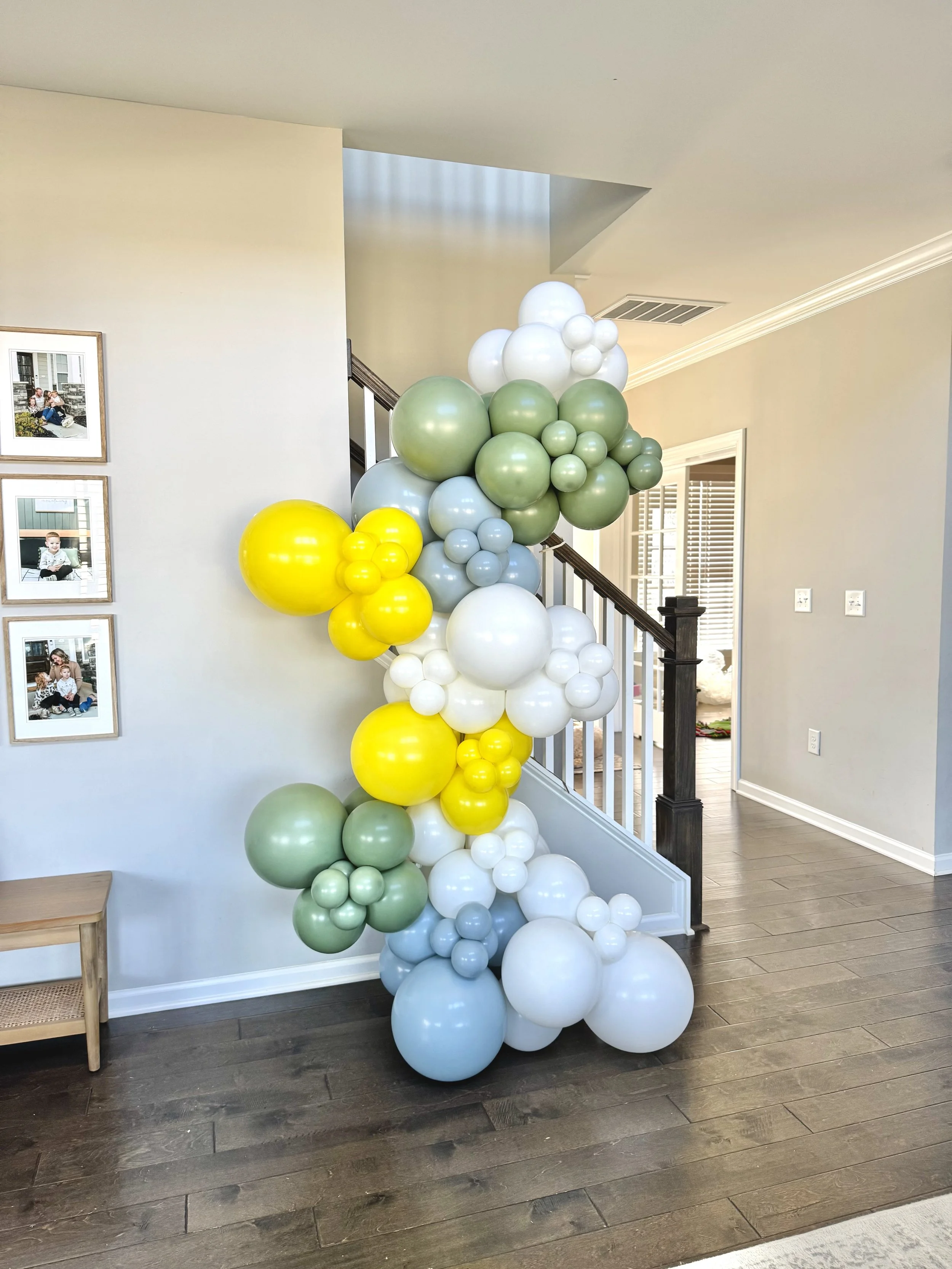 8-9ft organic standard garland attached to a balloon column
