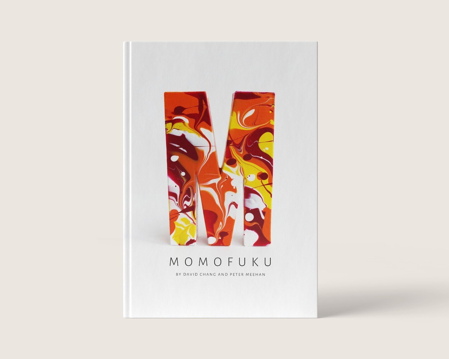 Handmade approach for the cover of David Chang's cookbook.

Momofuku is a cookbook where Asian and American cuisine is fused together to create new bold flavors and recipes. David Chang, the author, made his art accessible for everyone to try. This f