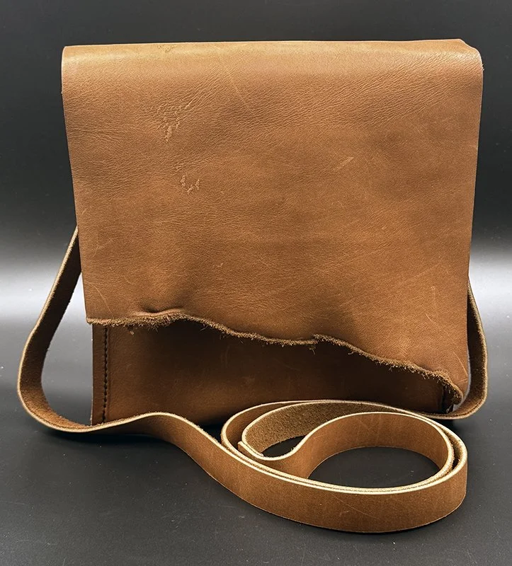 cross body bag with natural edge flap and back pocket, oil tanned leather, 8.5"h x 8.5"w x 3"d 
