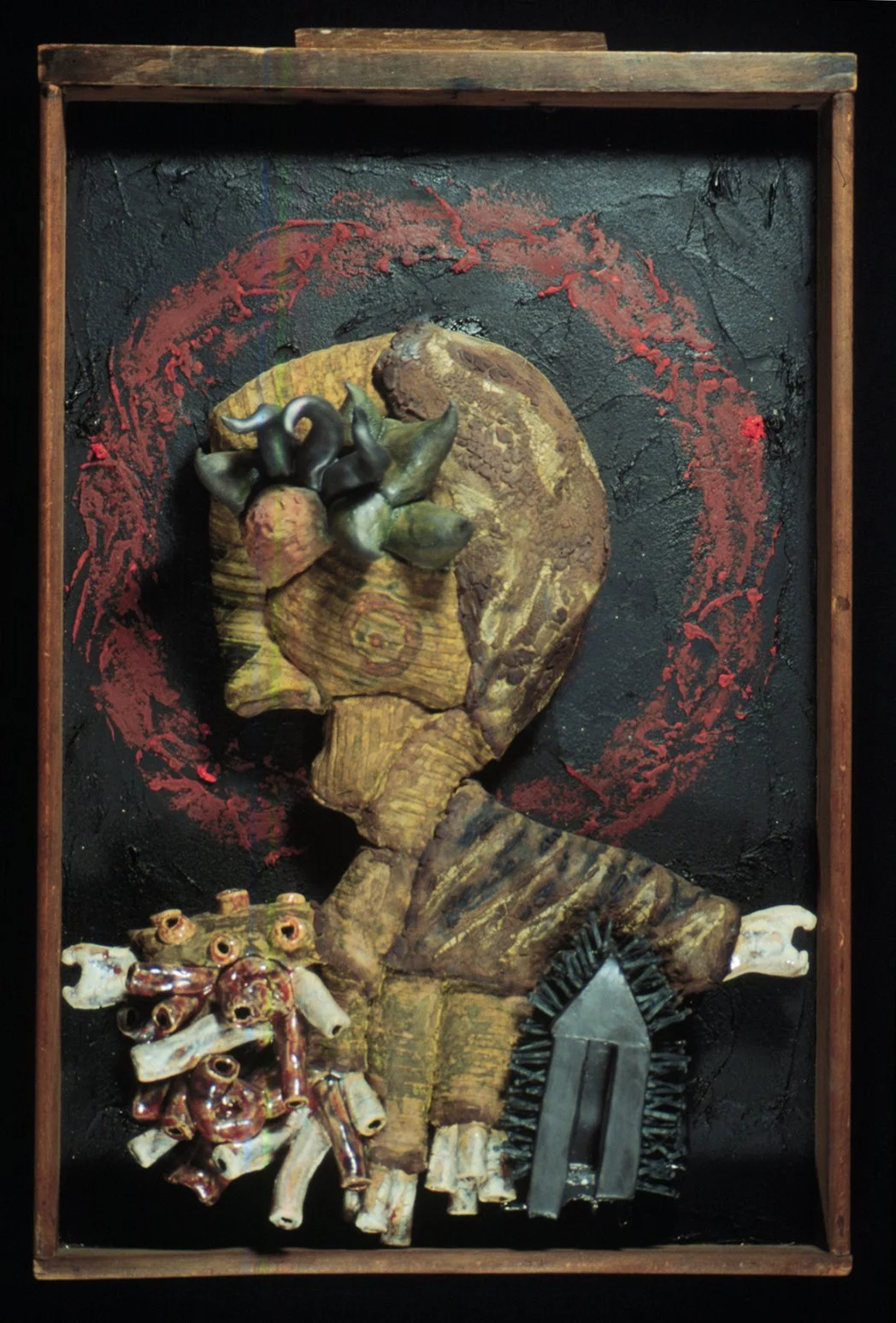 Easy Target,  23" x 25" x10", clay figure, multifired glaze and underglaze, nails, wooden drawer with tar and oil bar.  2000