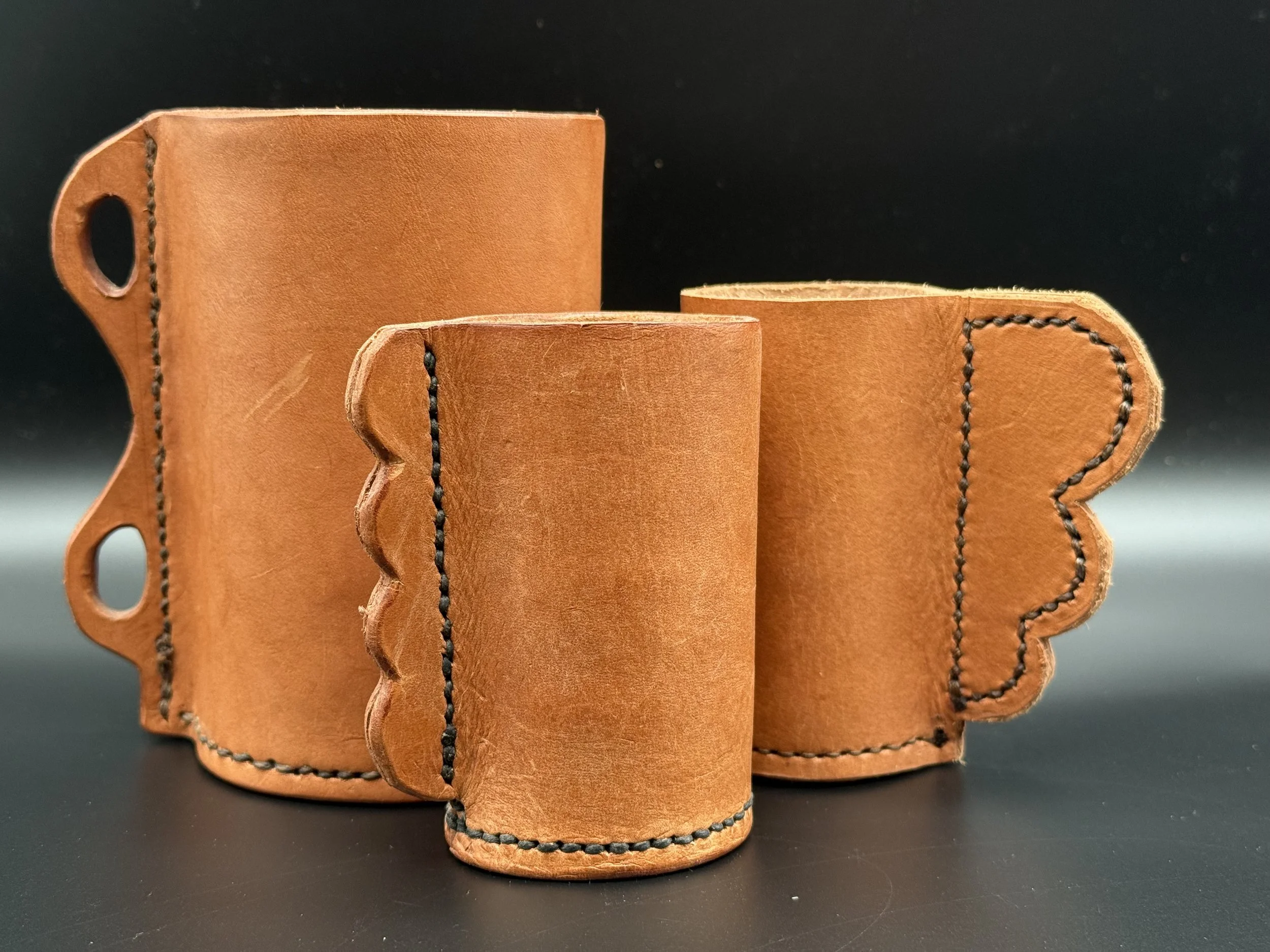 wet molded leather cups.  vegtan leather. assorted sizes (6"h - 4"h, 2" dia)