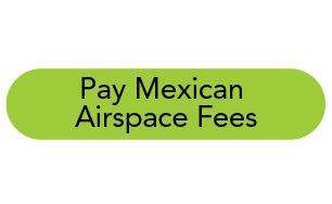 Green oval sign with black text reading 'Pay Mexican Airspace Fees'