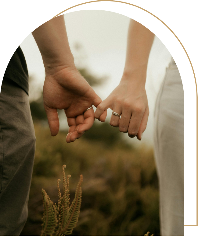 Two hands with pinkies intertwined standing in a field | Kathleen Killen Psychotherapy and Coaching