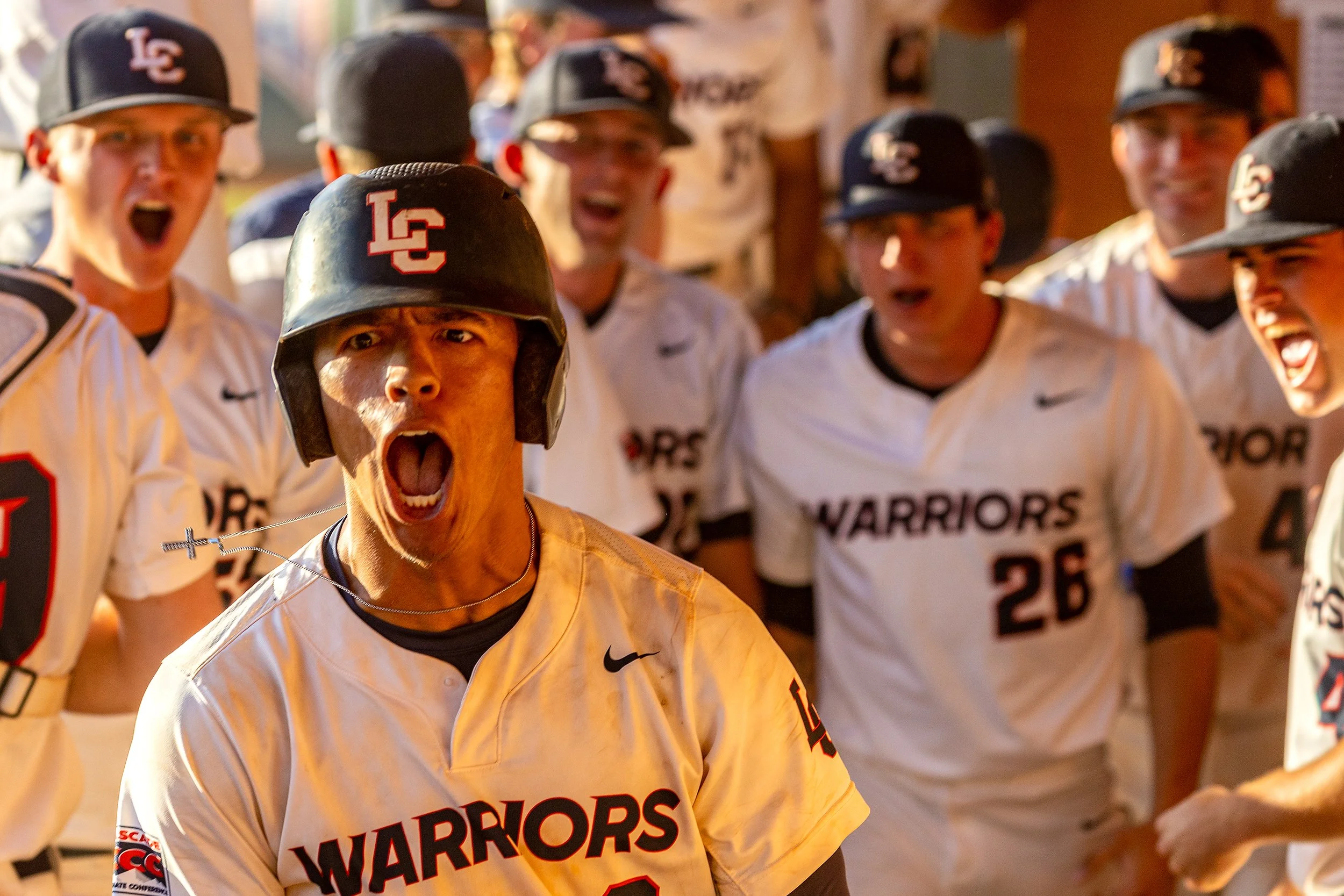 Lewis-Clark State outfielder Isaiah Thomas, left, returns to a rowdy dugout May 16, 2023, after hitting a grand slam in the fourth inning to give the Warriors their first lead over Concordia University during day two of the NAIA Opening Round at Harr