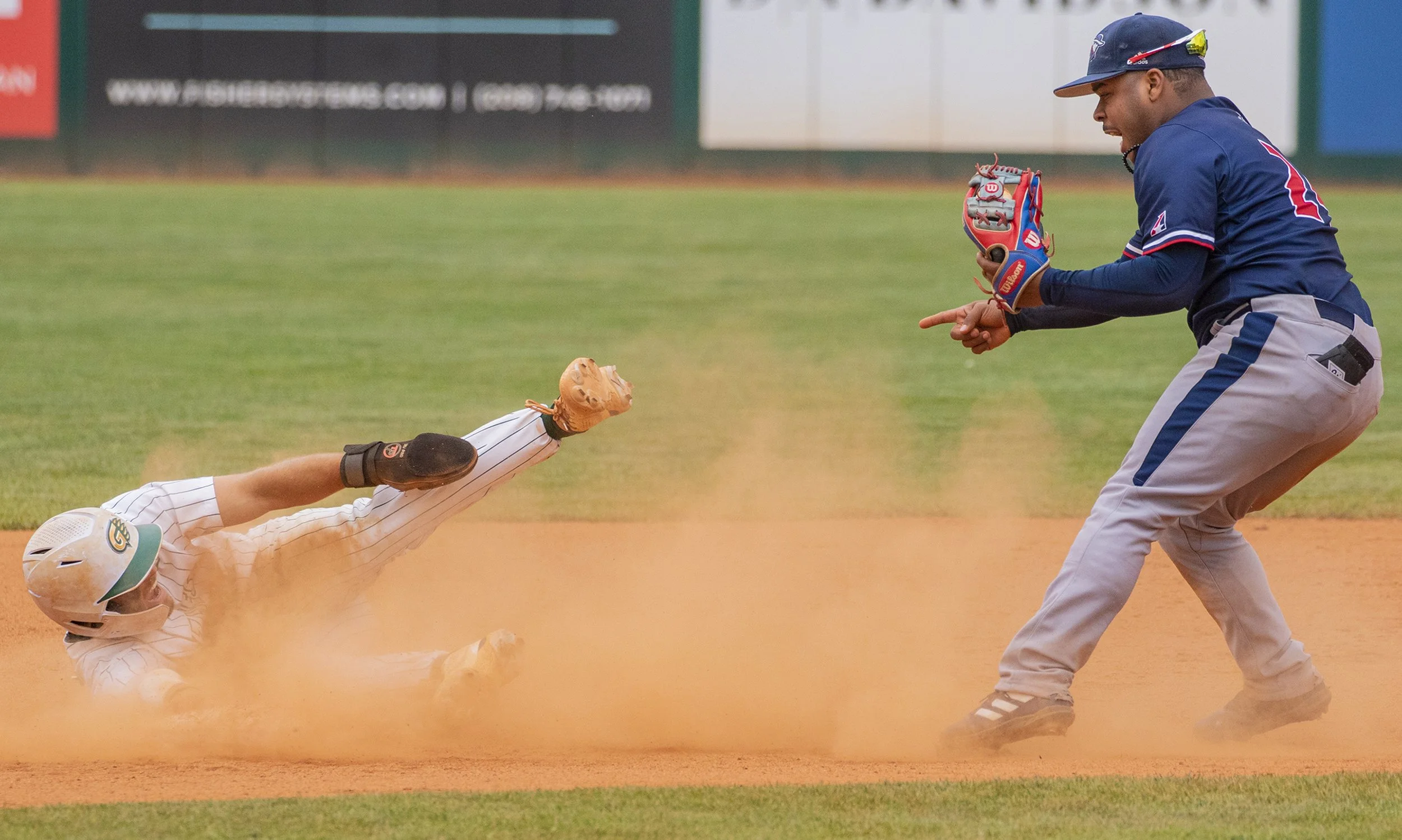 MidAmerica Nazarene second baseman Randy Fernandez, right, points to Georgia Gwinnett’s Jake Defries after tagging Defries out on an attempted steal May 27, 2022, during game one of the NAIA World Series at Harris Field in Lewiston, Idaho.