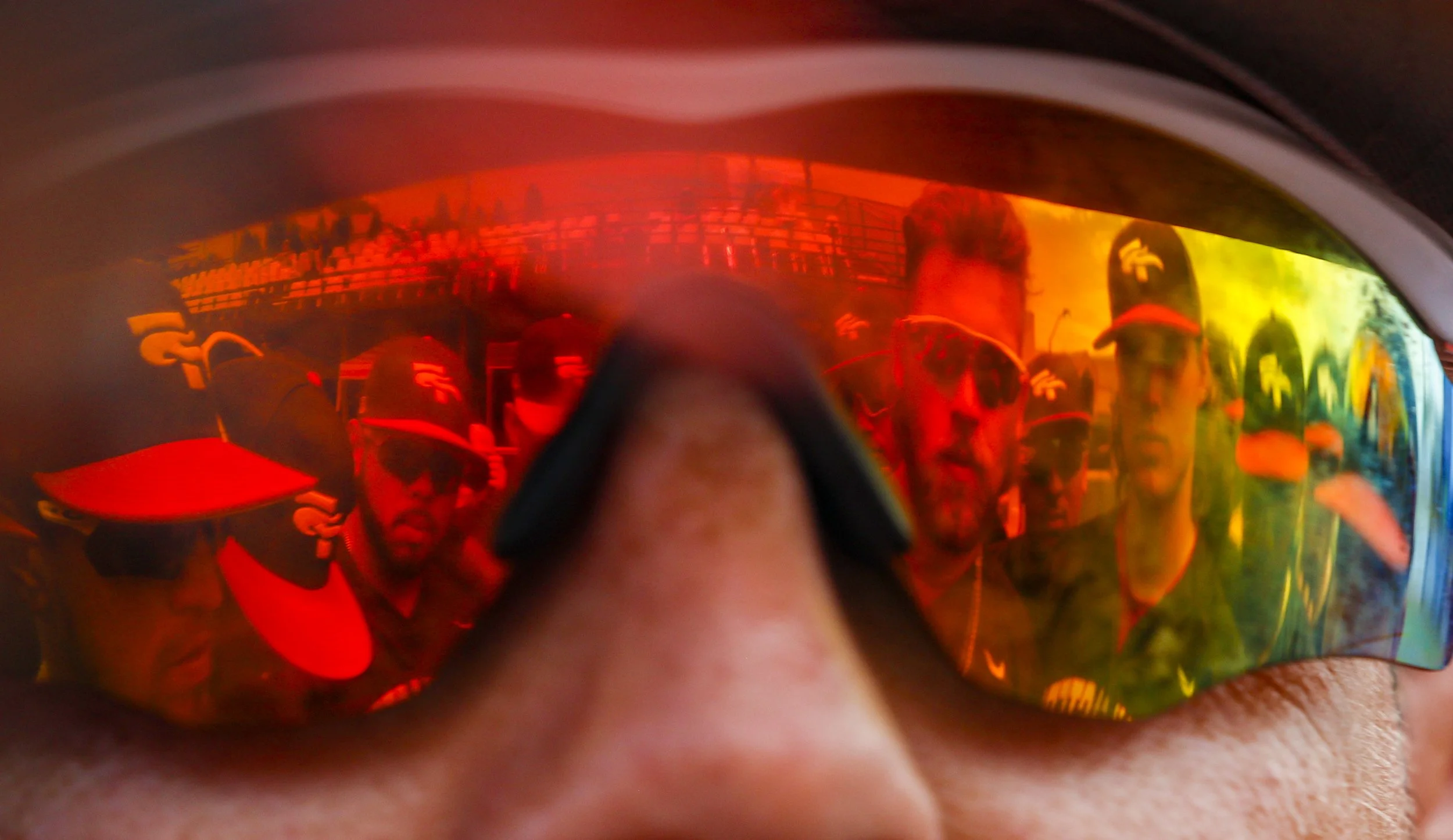 Southeastern Florida's starting bench reflects off the sunglasses of assistant coach Mike Mendoza as he rallies his team before game 18 of the NAIA World Series on June 2, 2022, at Harris Field in Lewiston, Idaho.