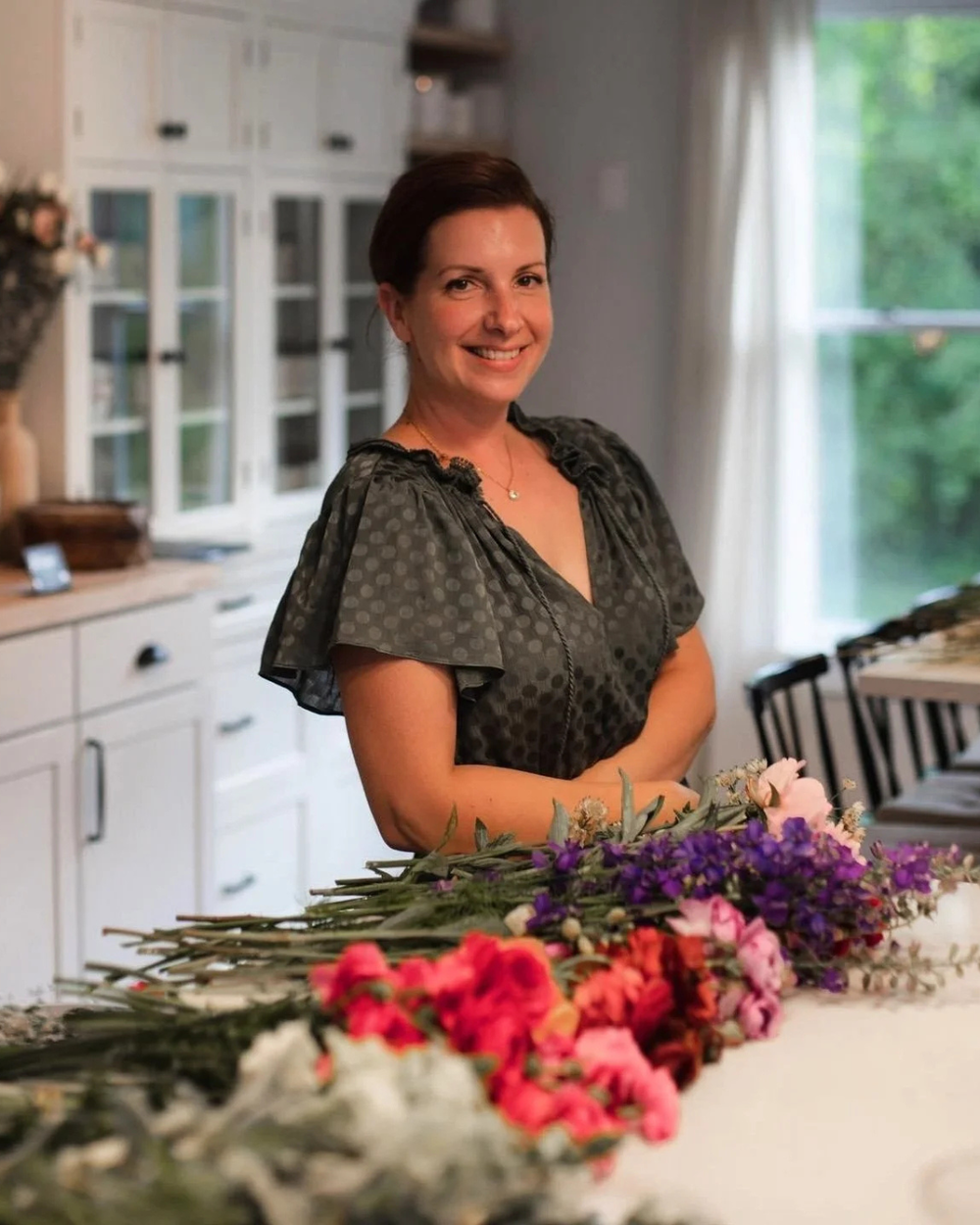 Amy, the designer behind Wild Floweress, among just-cut garden flowers