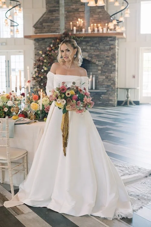 The bride before the dressed stone fireplace
