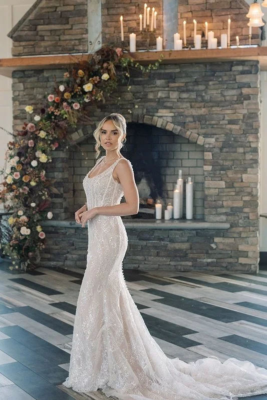 The bride beside the dressed stone fireplace