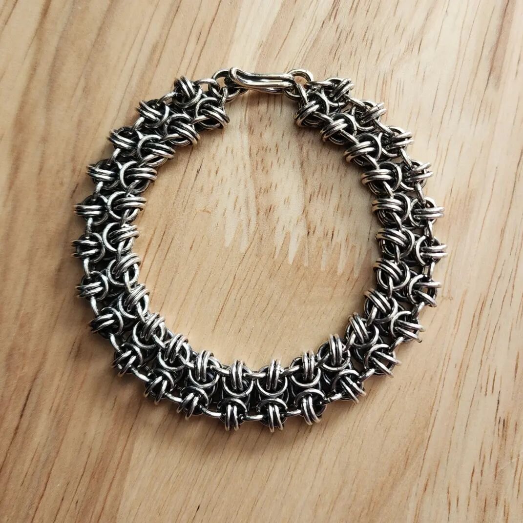 This is another beautiful statement piece that is substantial on your wrist. This is a byzantine gridlock weave chain mail bracelet with a hook and eye clasp. The links are 18 gauge sterling silver and the clasp is made from 16 gauge sterling silver 