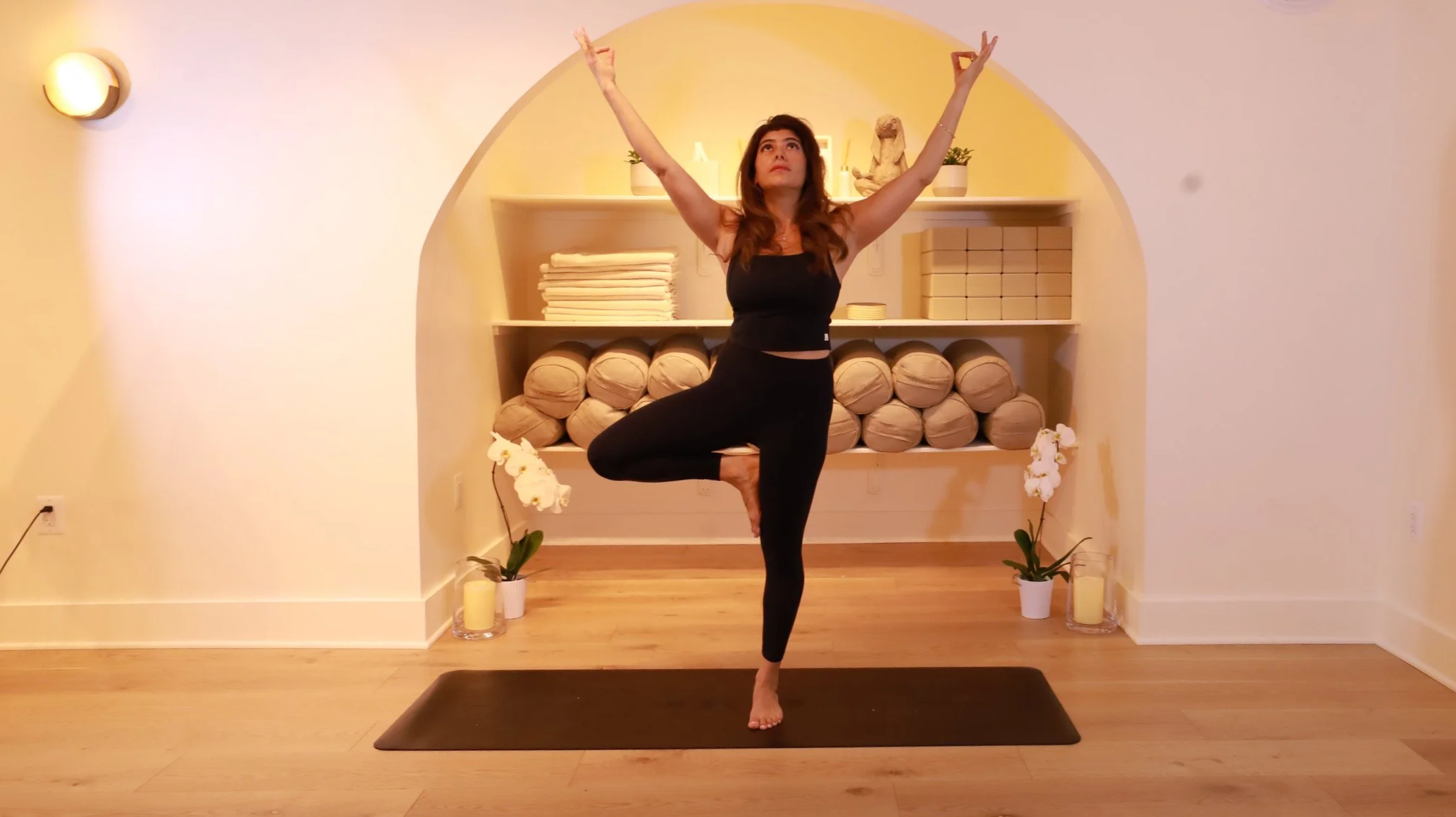 Yoga teacher practicing Tree Pose in the Lūneh Yoga studio in Dupont Circle, Washington, DC.