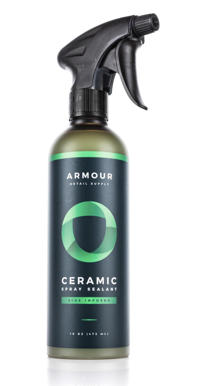 A 16 oz bottle of Armour Ceramic Spray Sealant with a black spray nozzle, labeled as SIO2 infused, with a dark blue and green label.