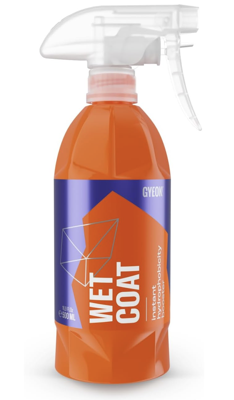 A spray bottle of GYEON Wet Coat, a hydrophobic detailing spray, with an orange and blue label and an orange body.