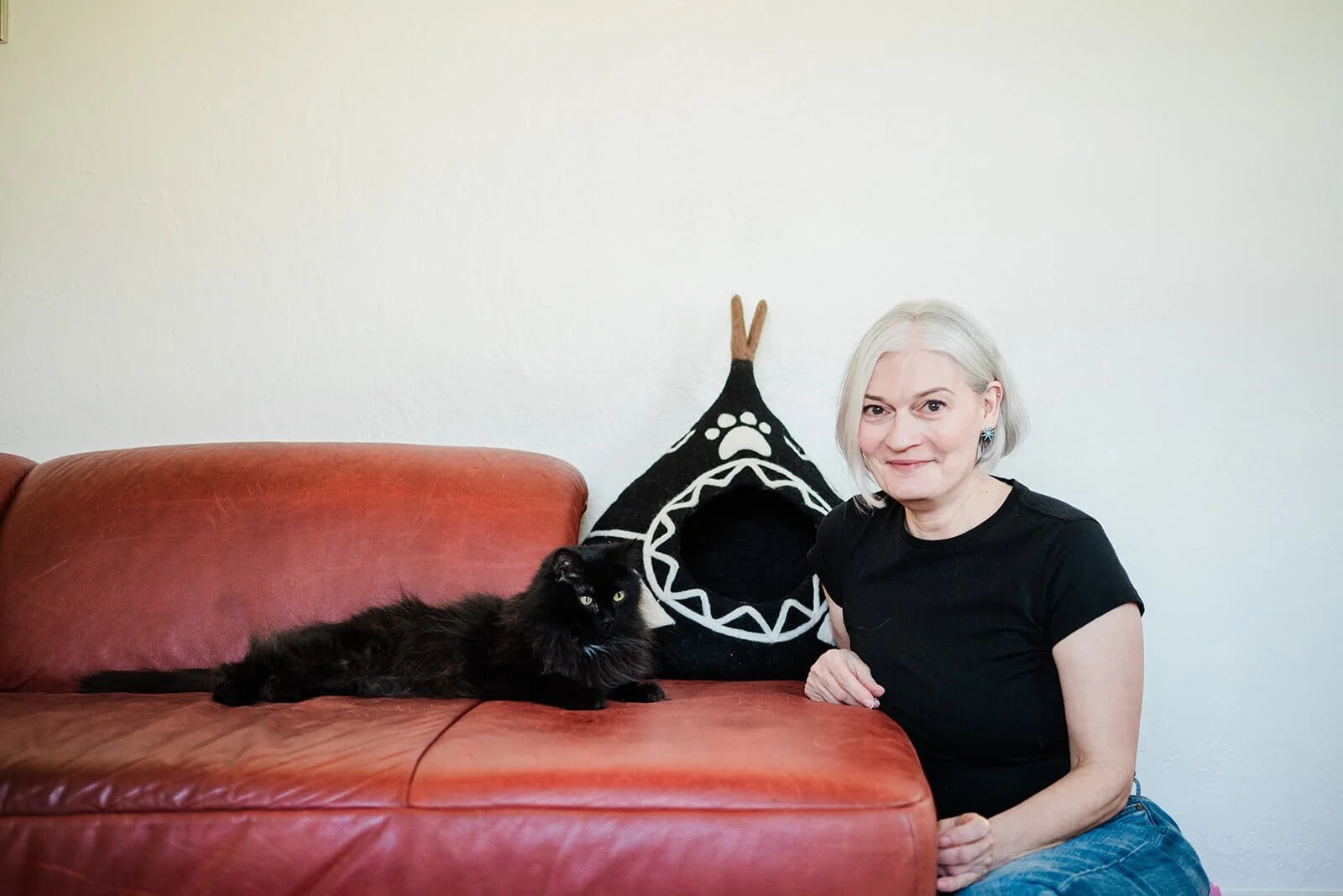 Photo of Sandra Grossmann, The Feline Consultant, interacting with a cat.
