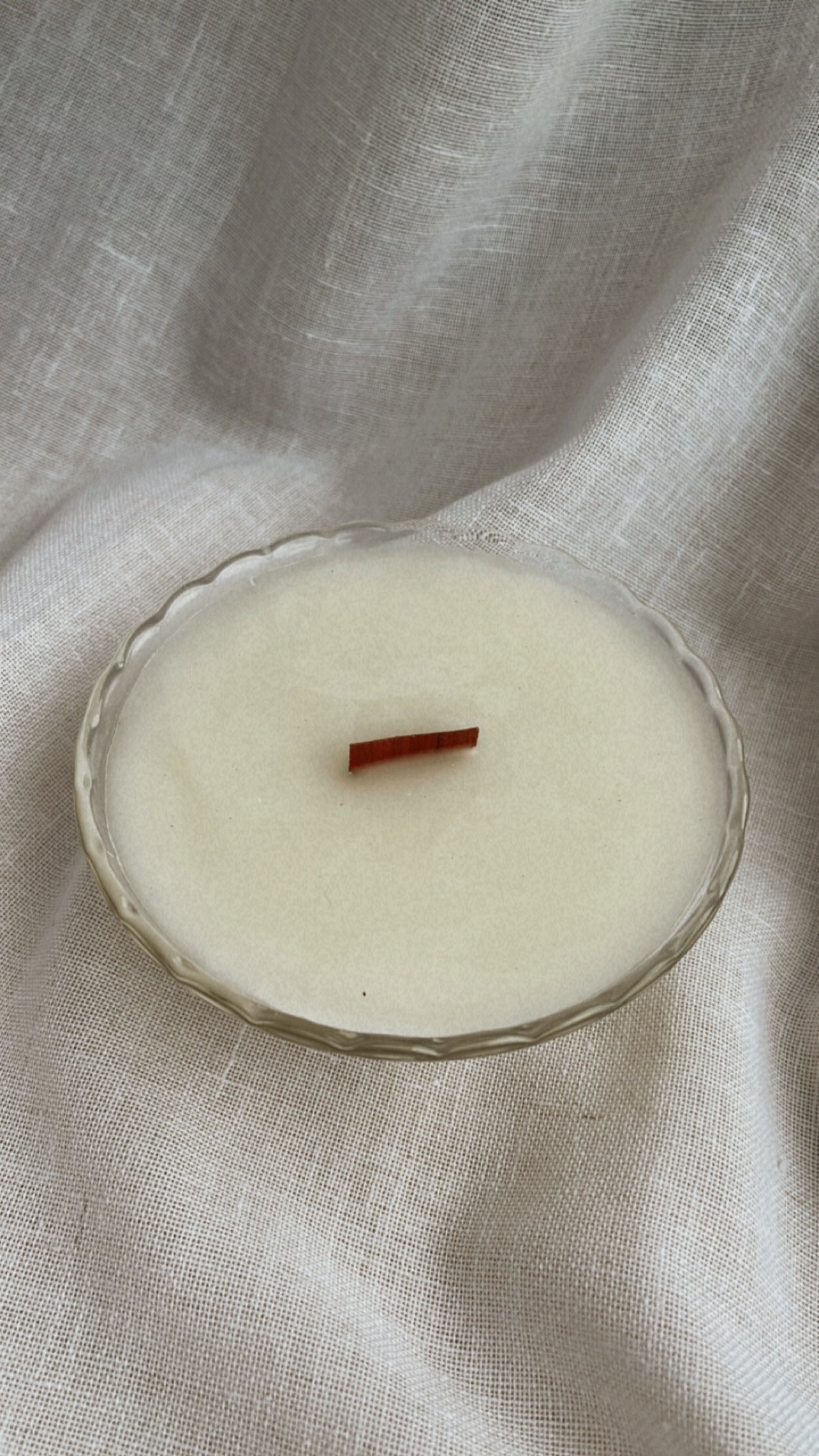 100% ivory beeswax hand poured into a gorgeous vintage crystal glass dish bowl with a scalloped rim and botanical etching around a wooden crackling wick, giving off the coziest ambiance.