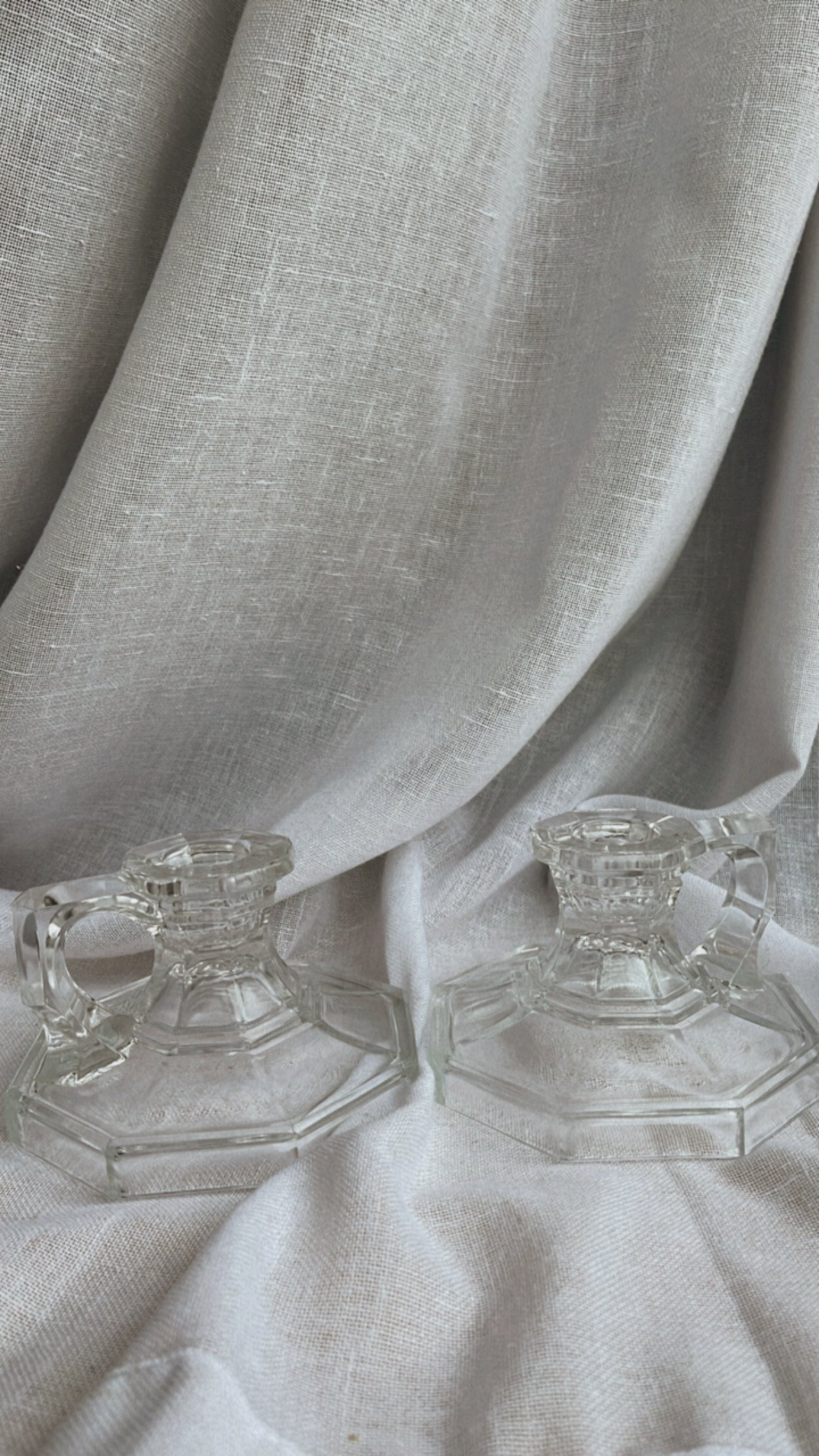 A gorgeous set of vintage crystal glass candlestick holders that bring a timeless elegance into your space.