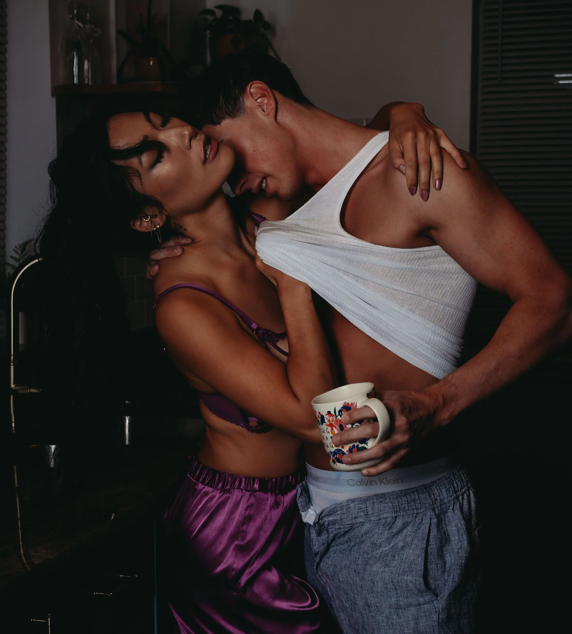 couple in kitchen in romantic embrace