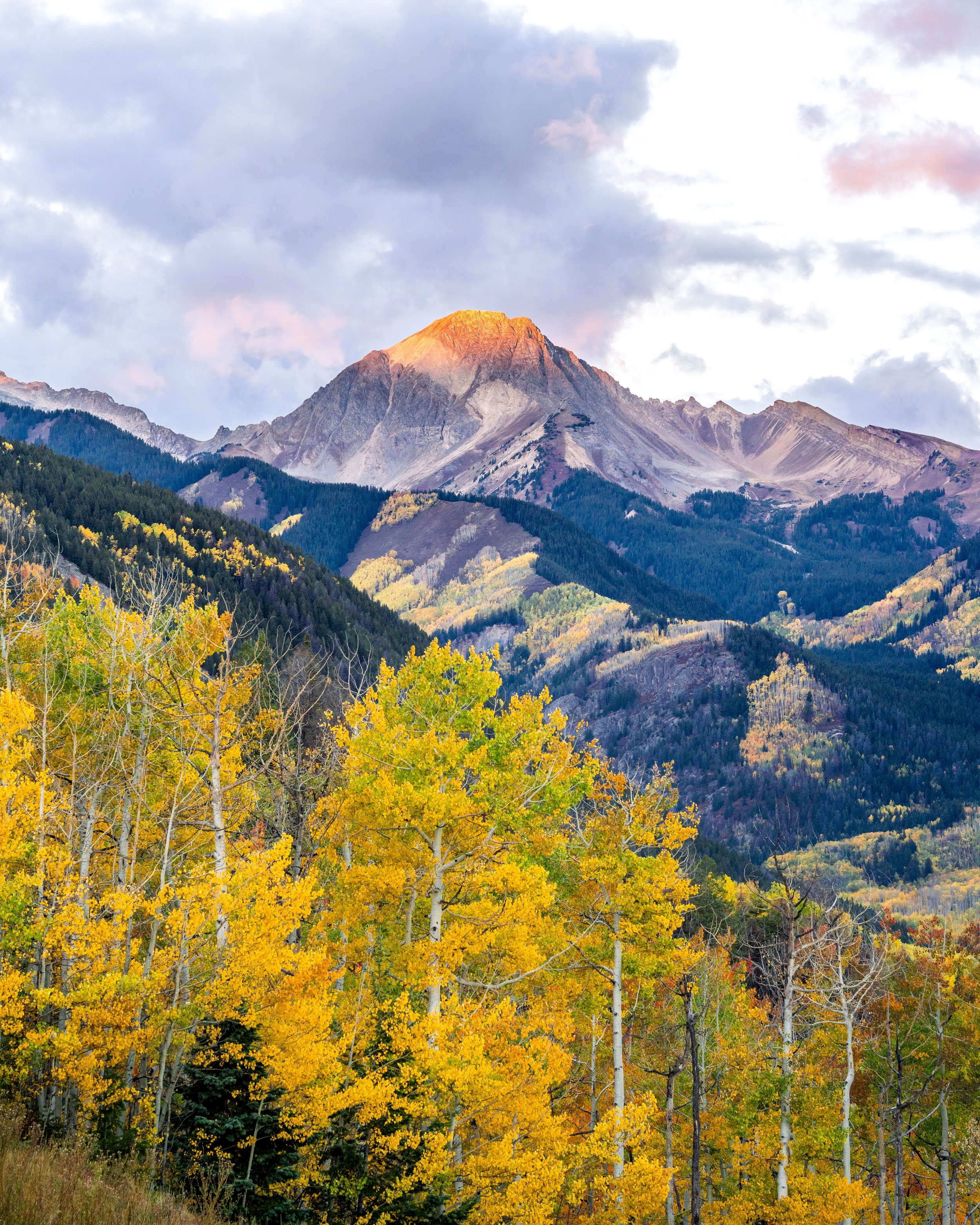 Fall colors blanket the valley below Mt Daly at first light