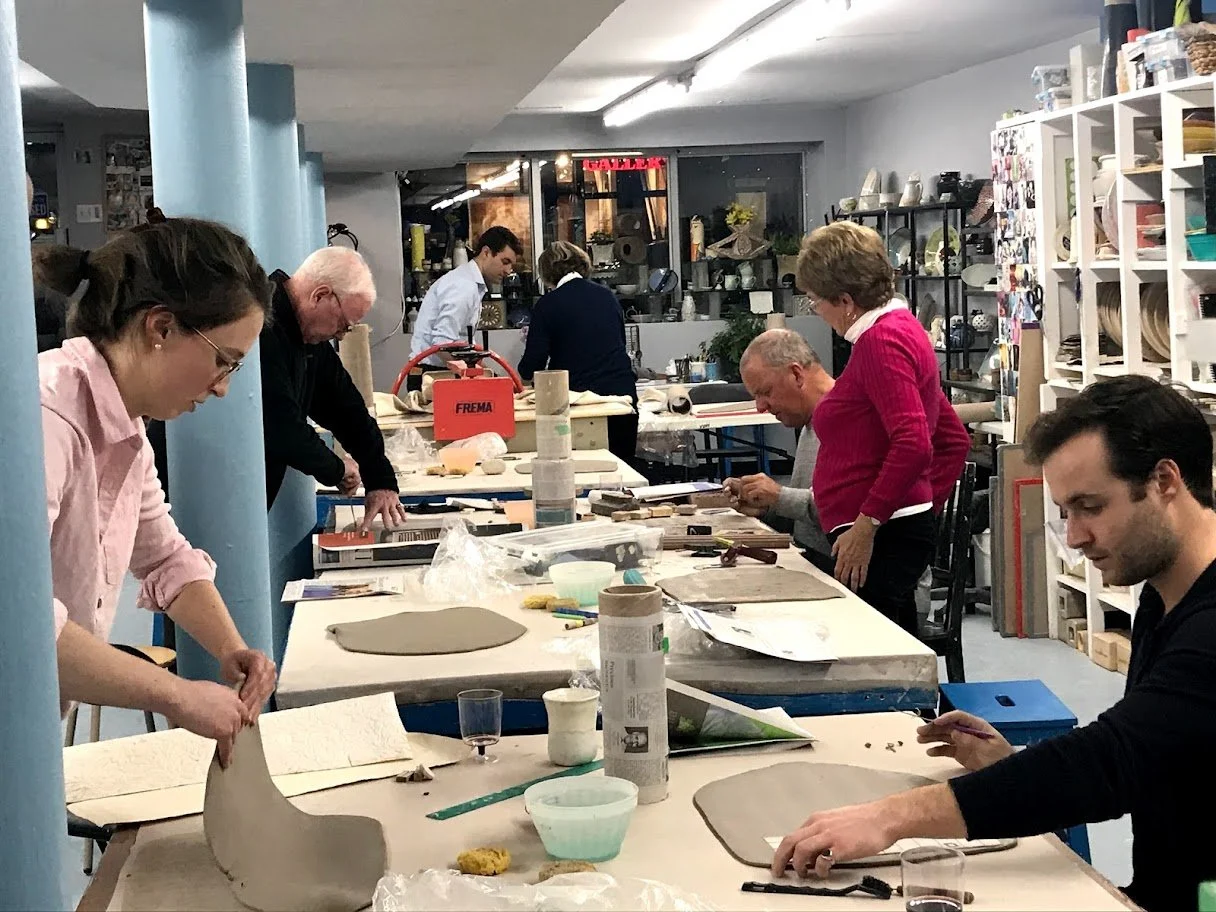 Picture of a pottery class being led with instructor.