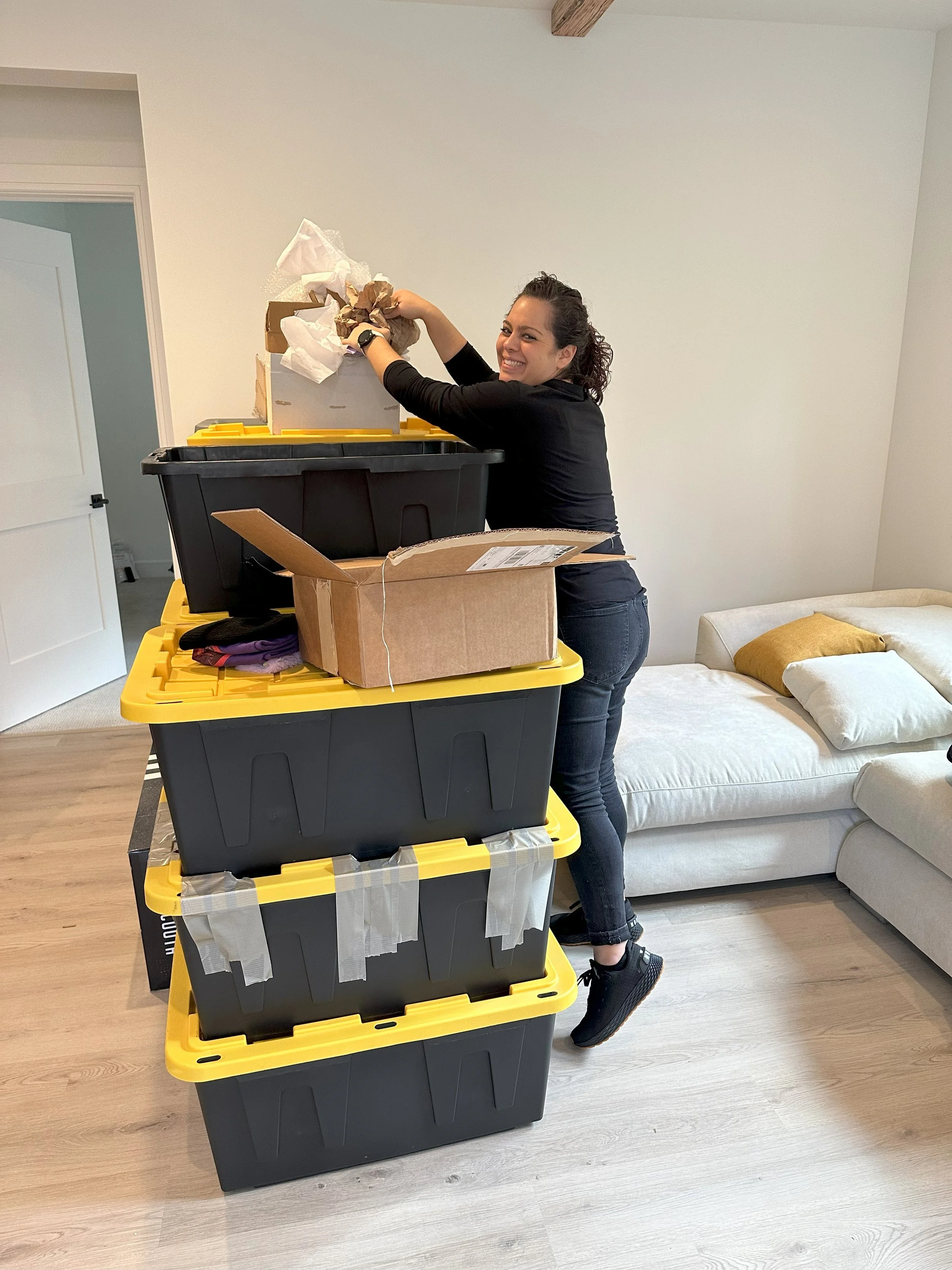 Crew member chatting and having a blast while packing boxes.