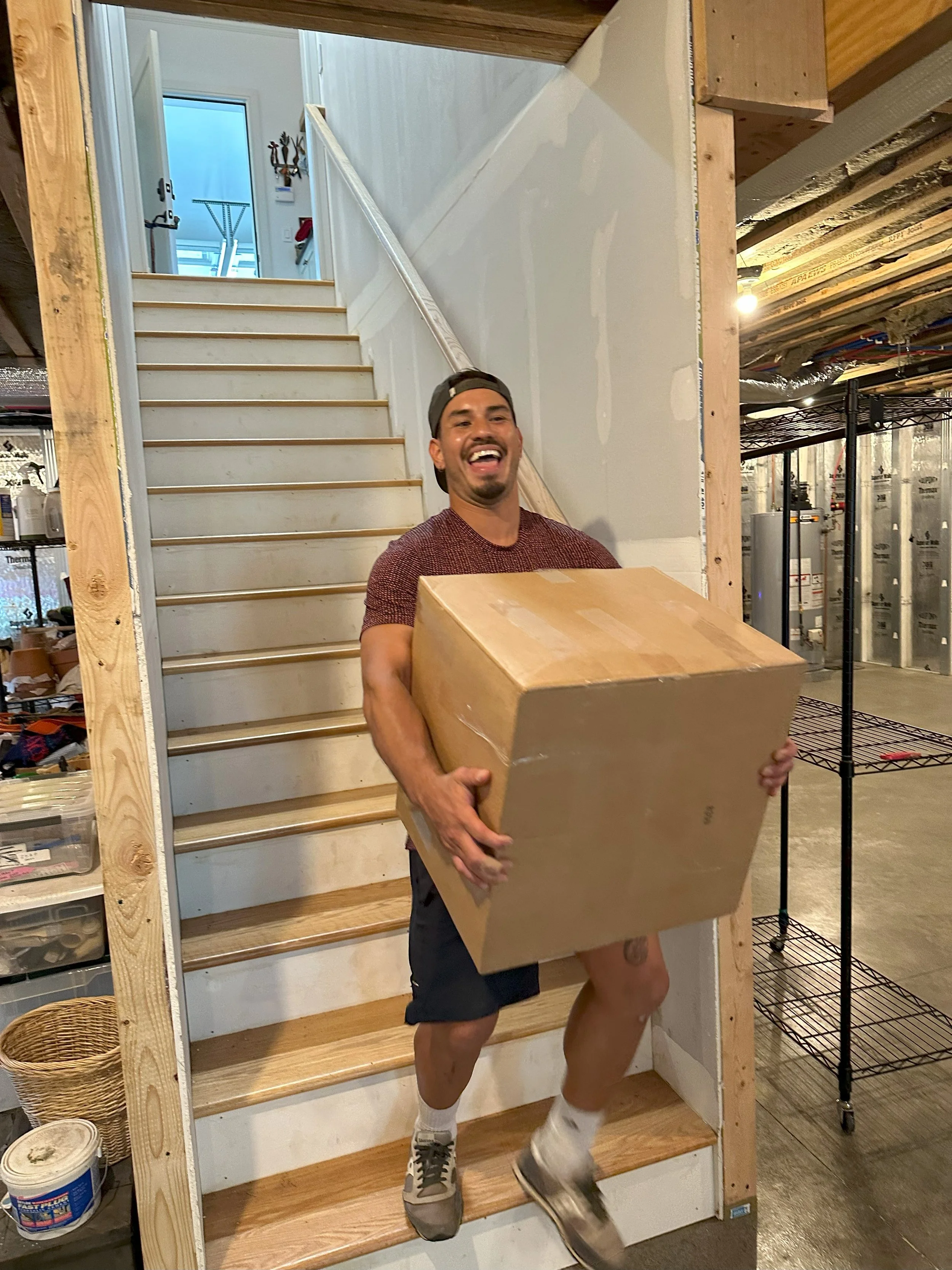 Crew member Aldo laughing at a joke at a job site.