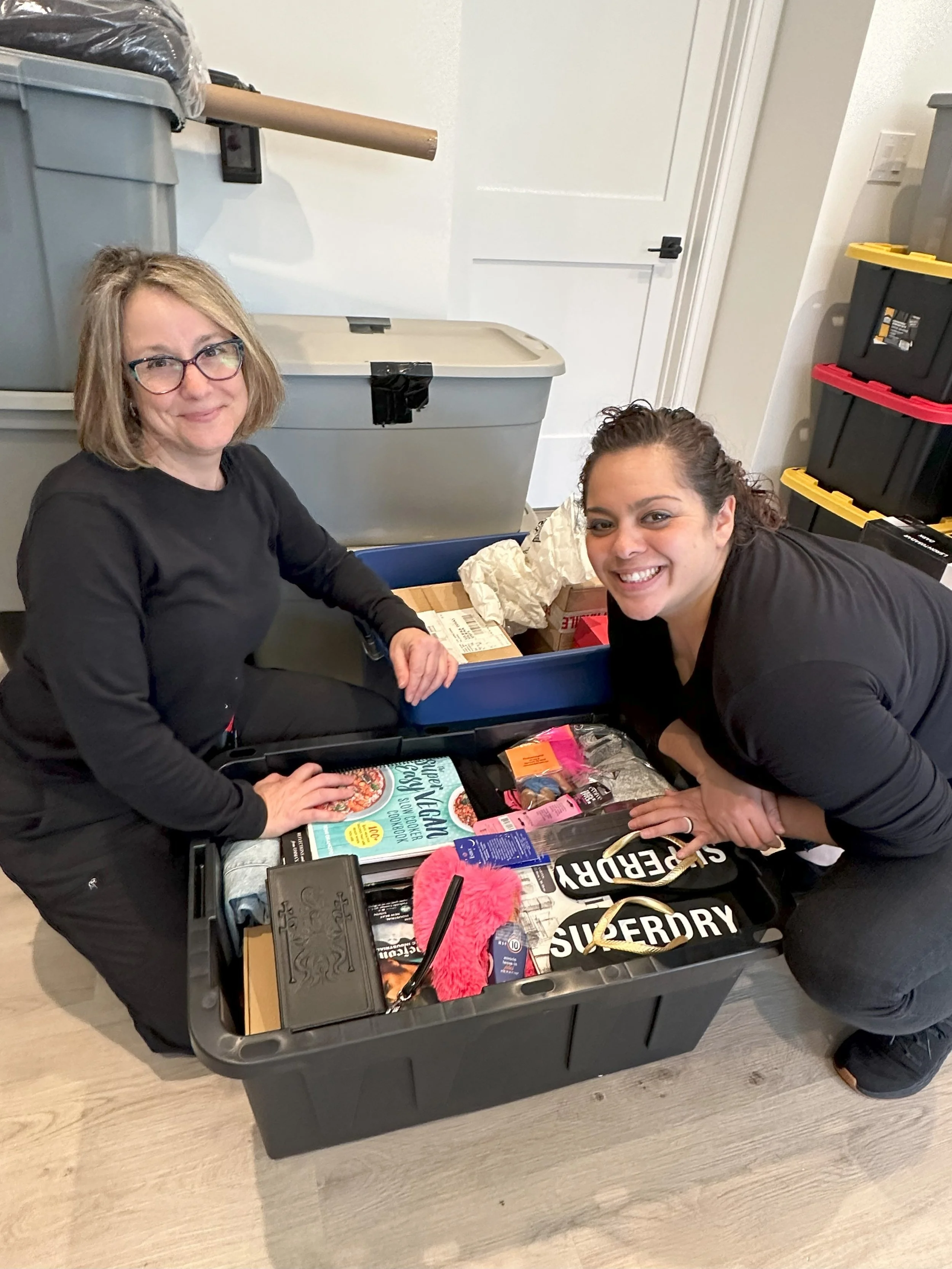 2 crew members working together to organize bins.