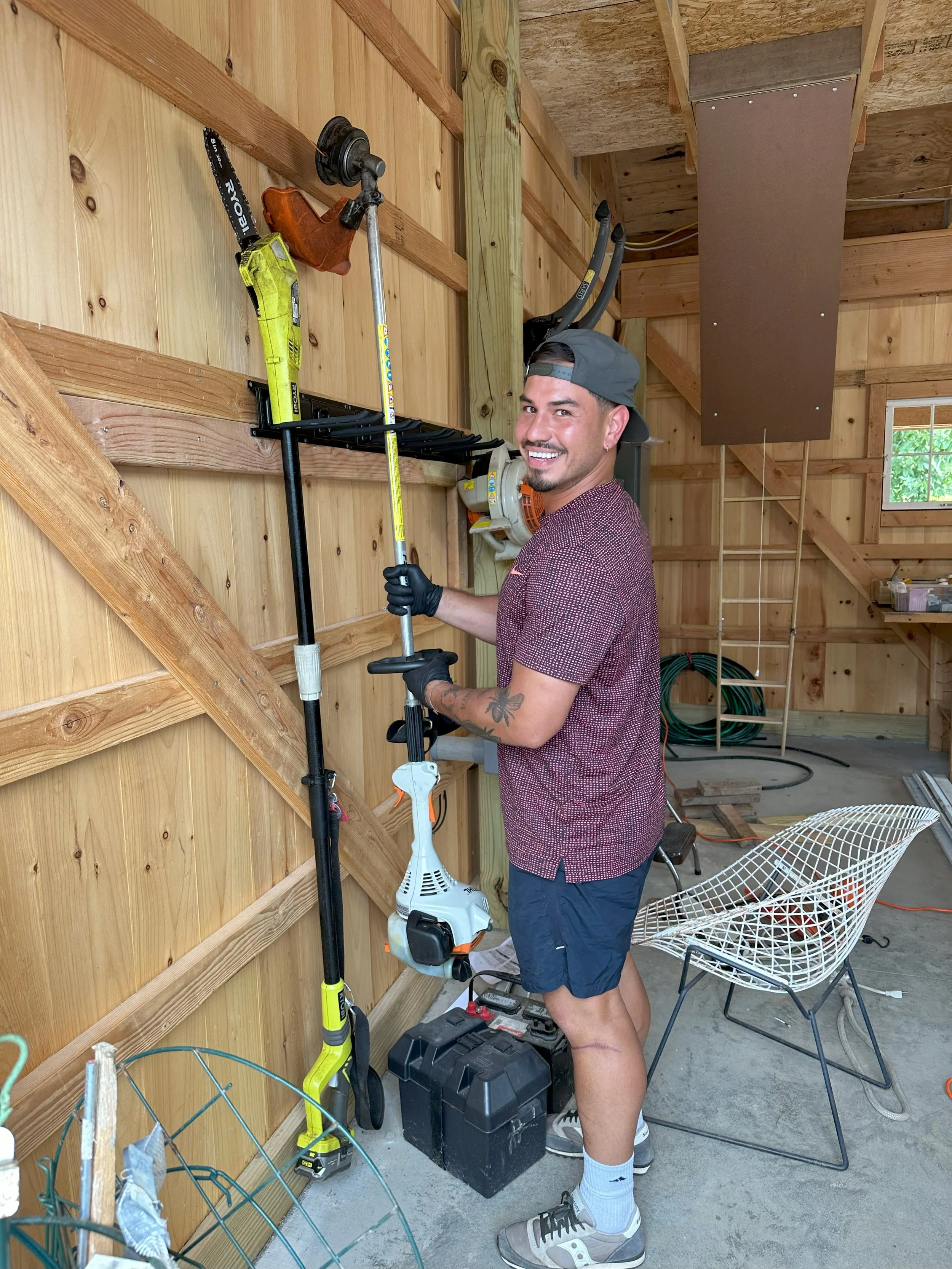 Refresh crew member, Aldo, organizing lawn maintenance tools.