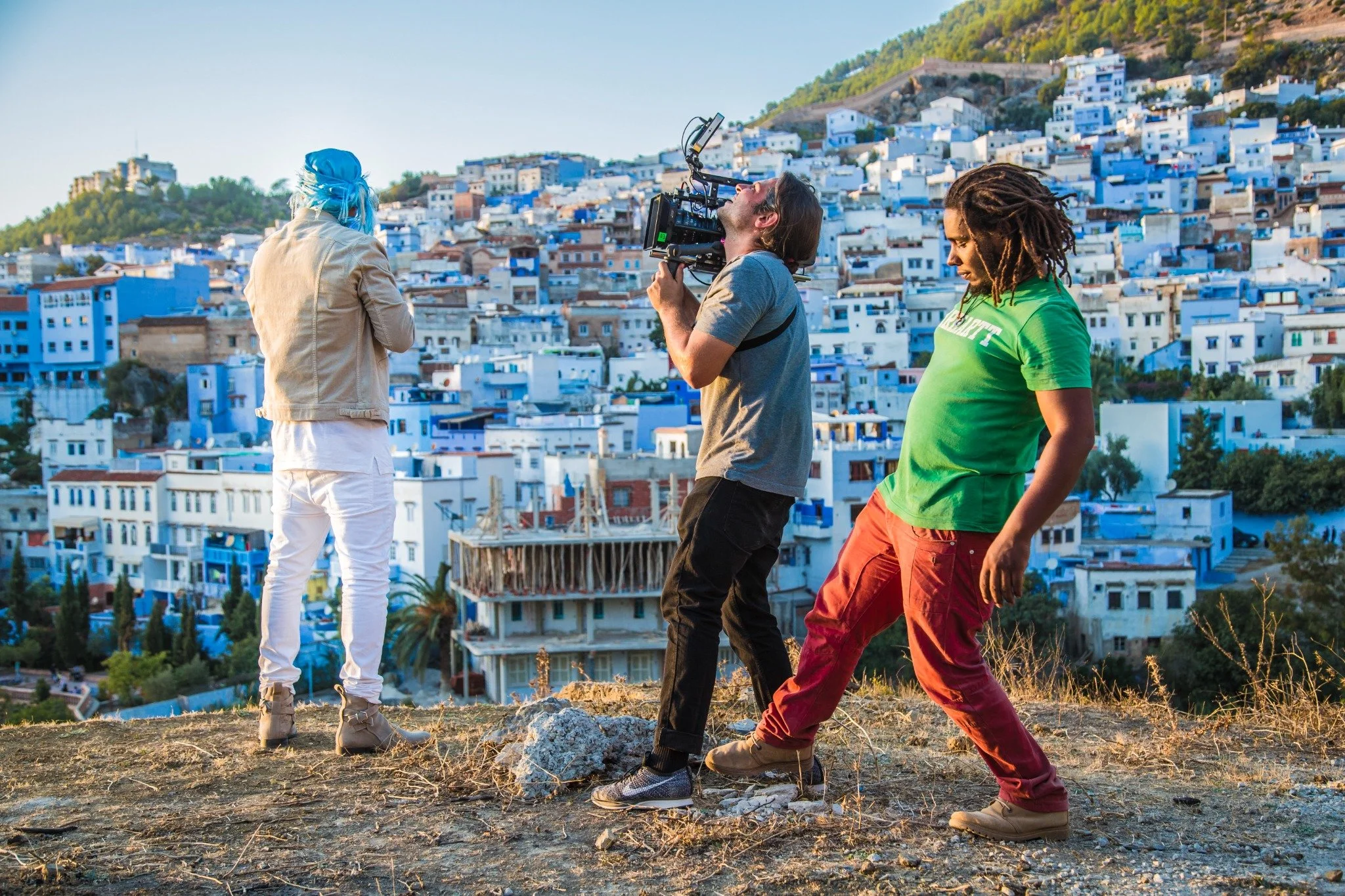 Camera crew filming French Montana’s Famous music video with Chefchaouen’s blue hillside buildings in the background